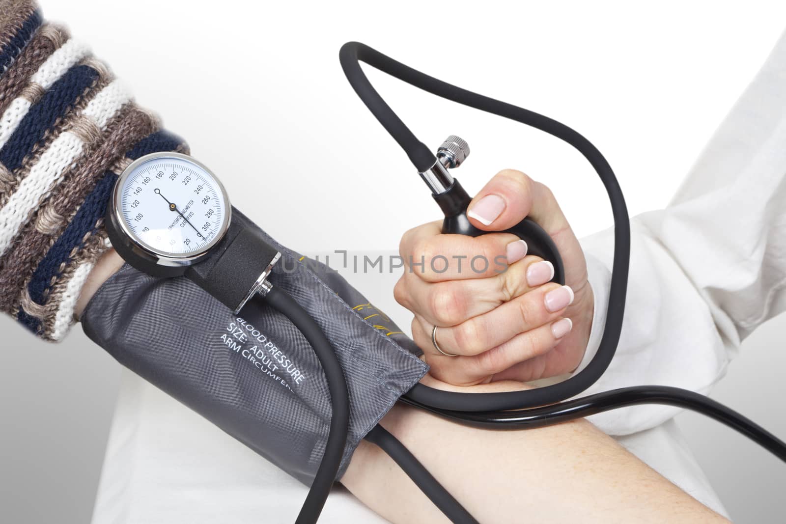 The doctor measures blood pressure in the patient