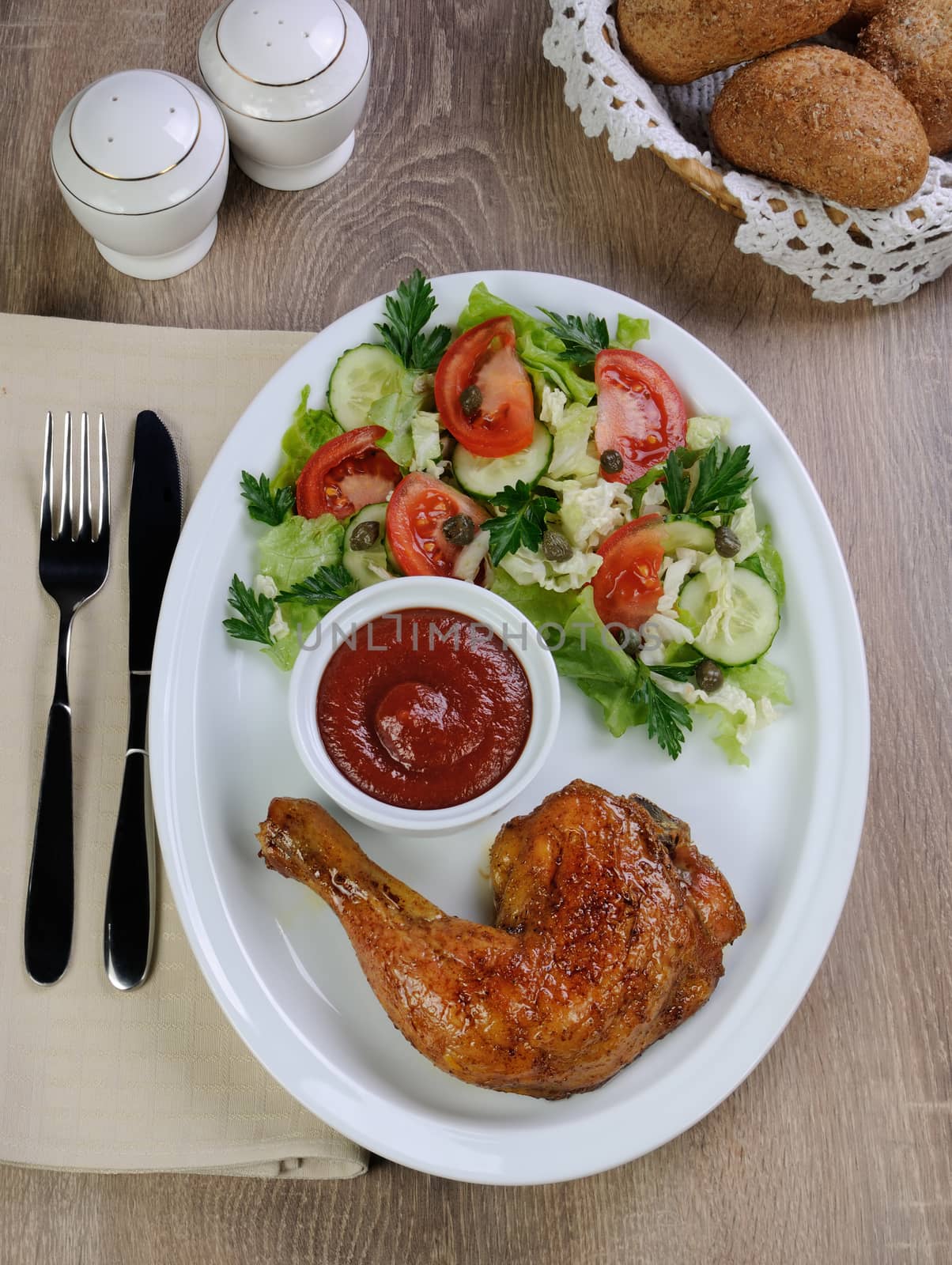 Baked chicken thigh with sauce and salad