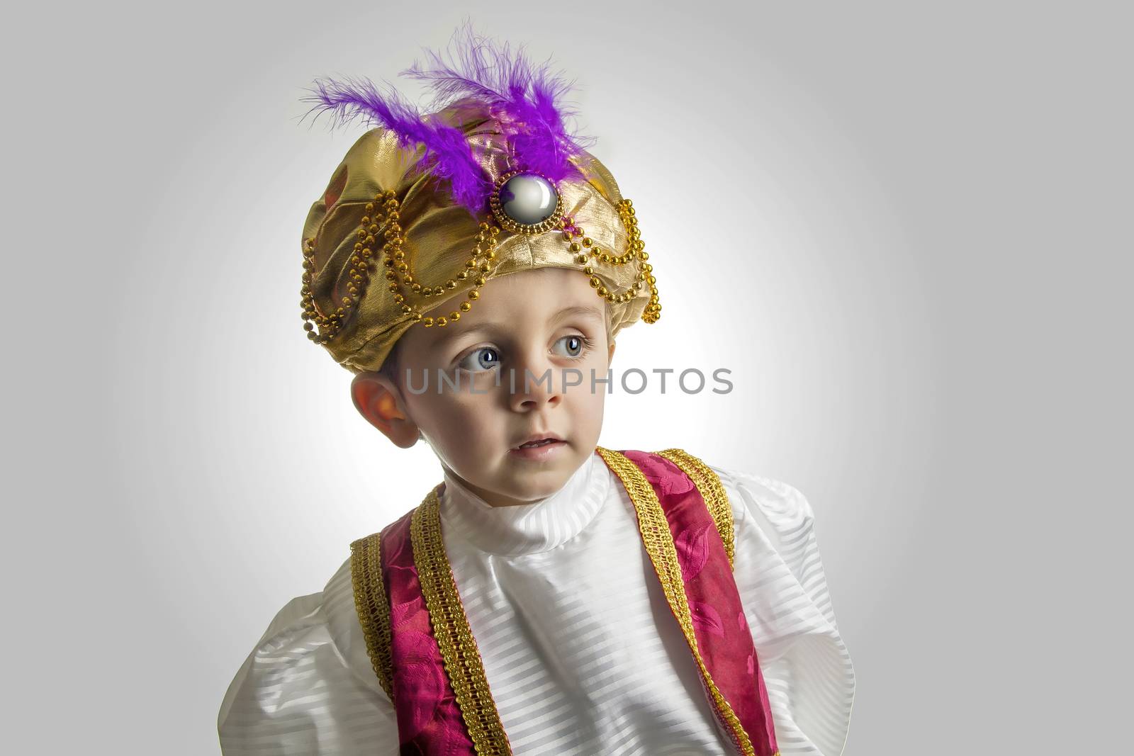 Child posing in sultan costume
