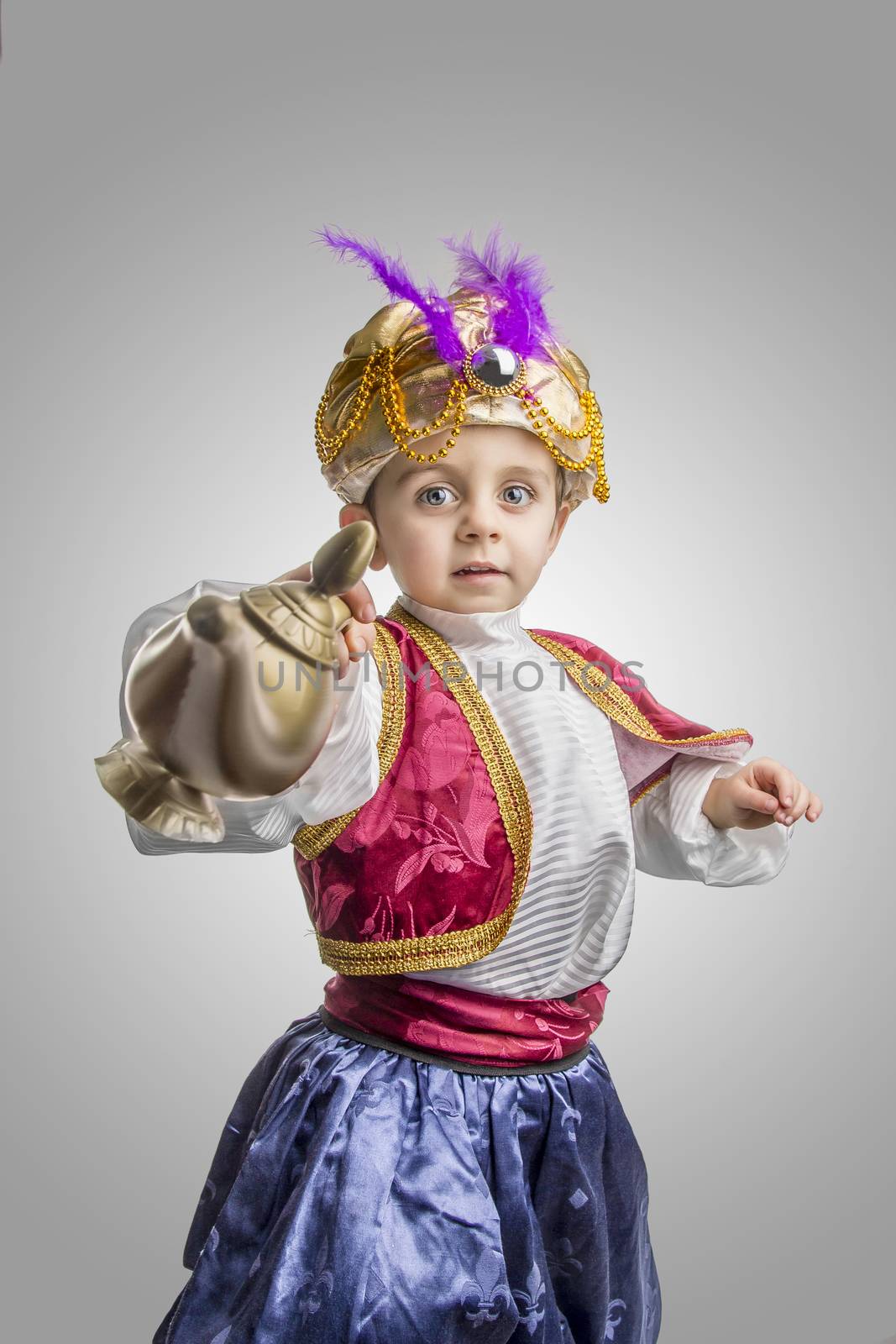 Child in sultan costume with lamp
