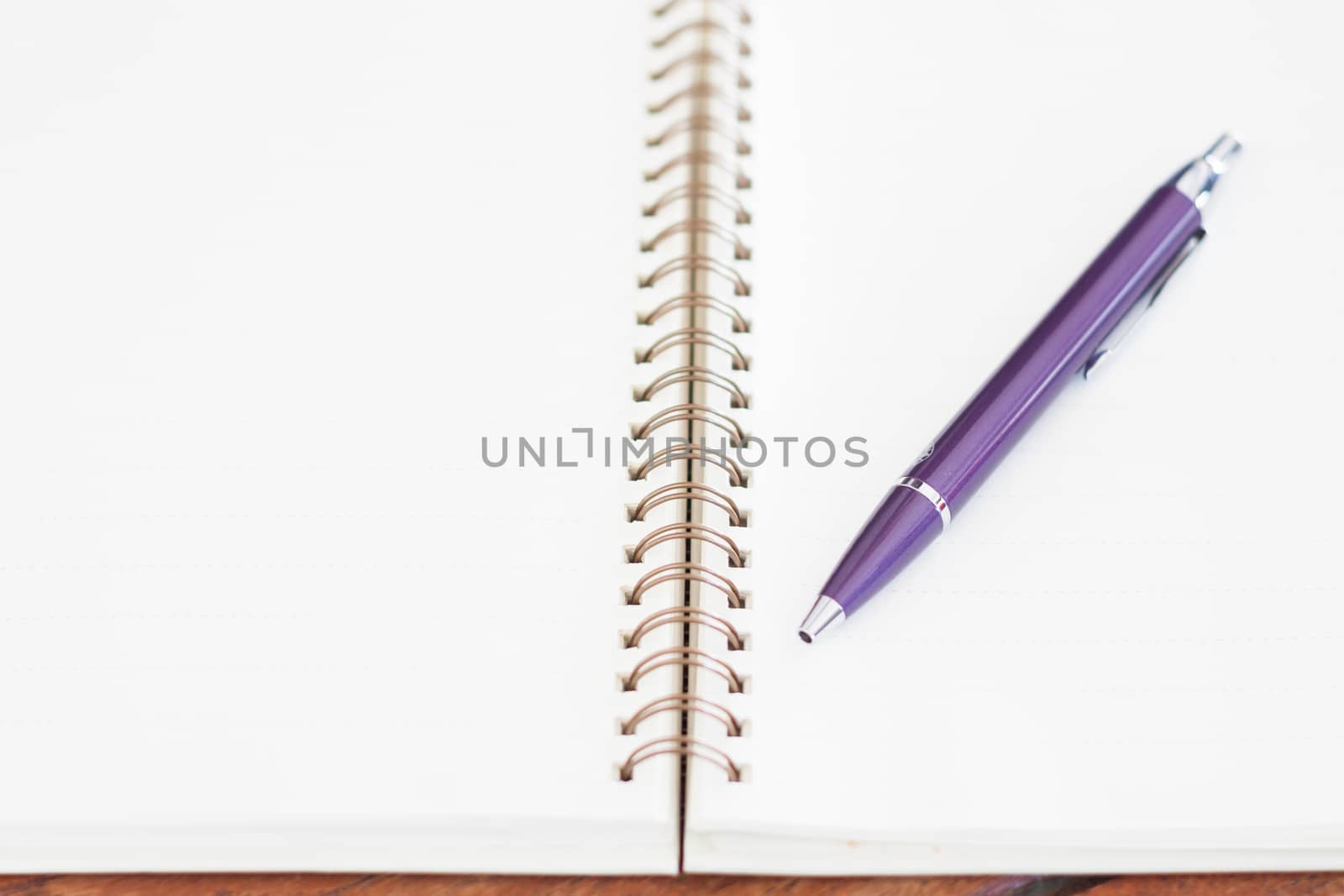 Blank notebook with pen on wooden table, stock photo