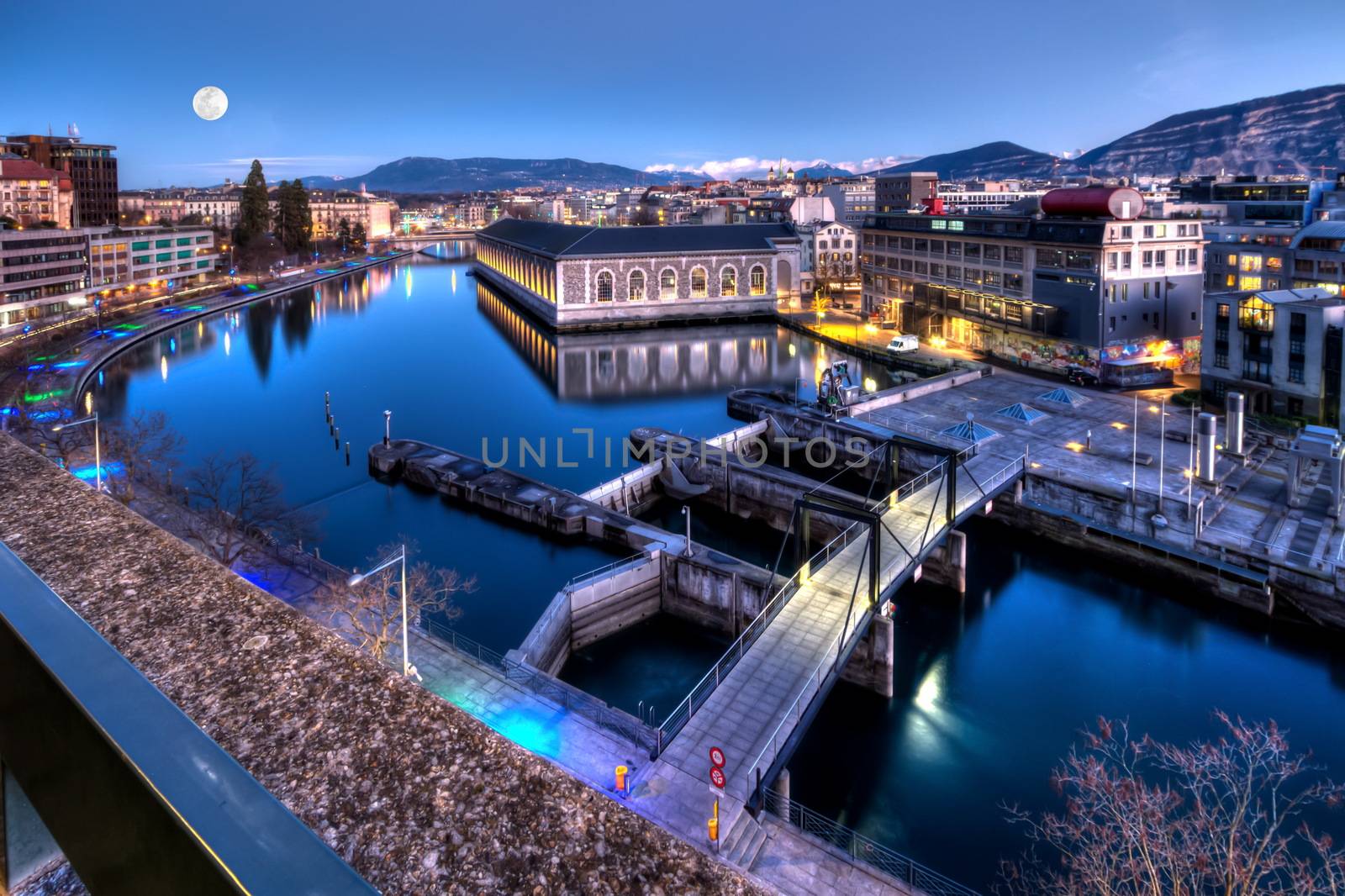 BFM, cathedral Saint-Pierre green tower and Rhone river by night with full moon, Geneva, Switzerland, HDR