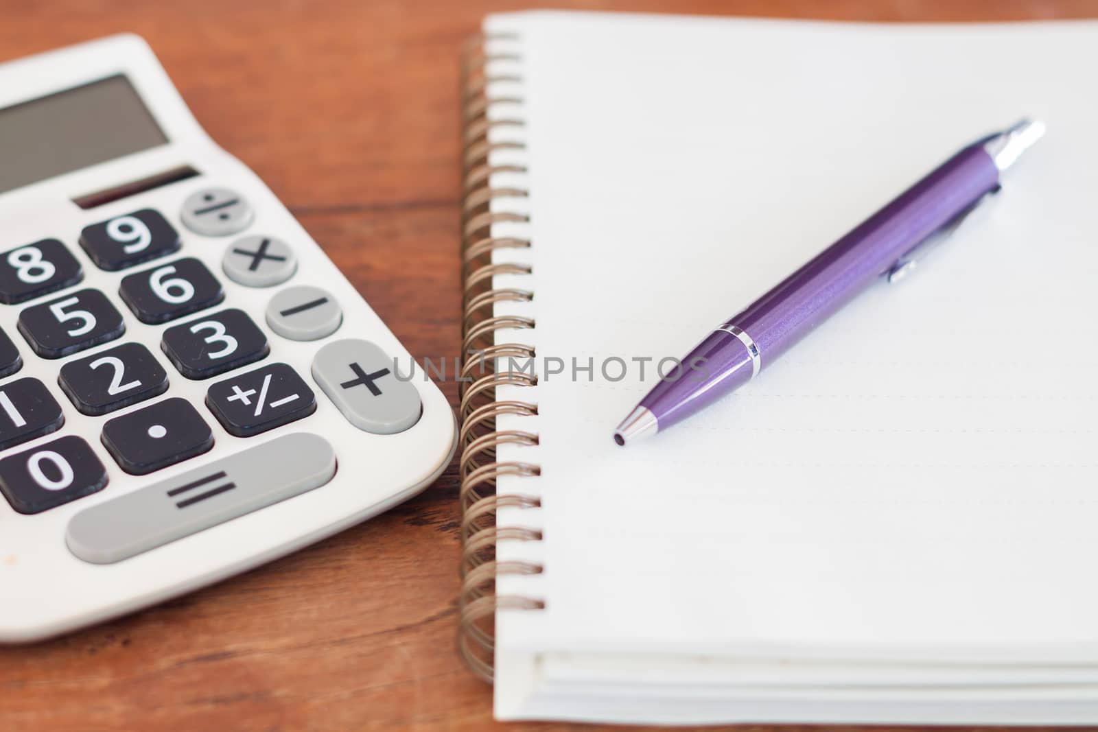 Blank notebook with pen on wooden table, stock photo
