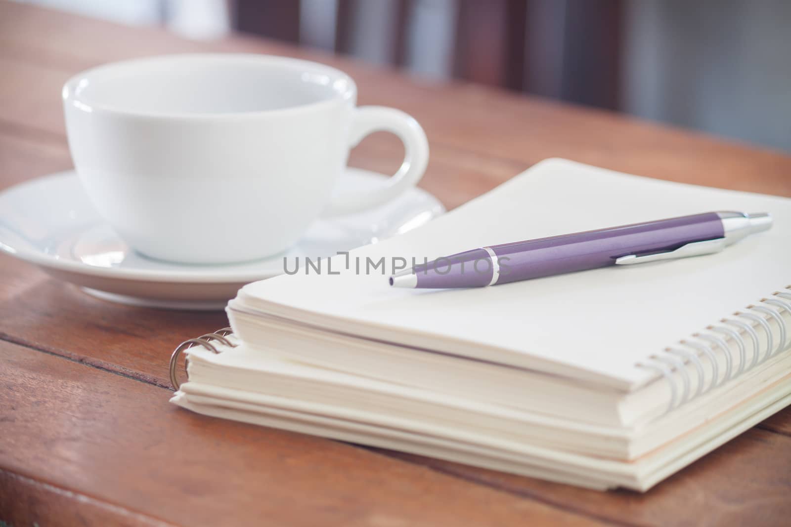Blank notebook with pen on wooden table, stock photo