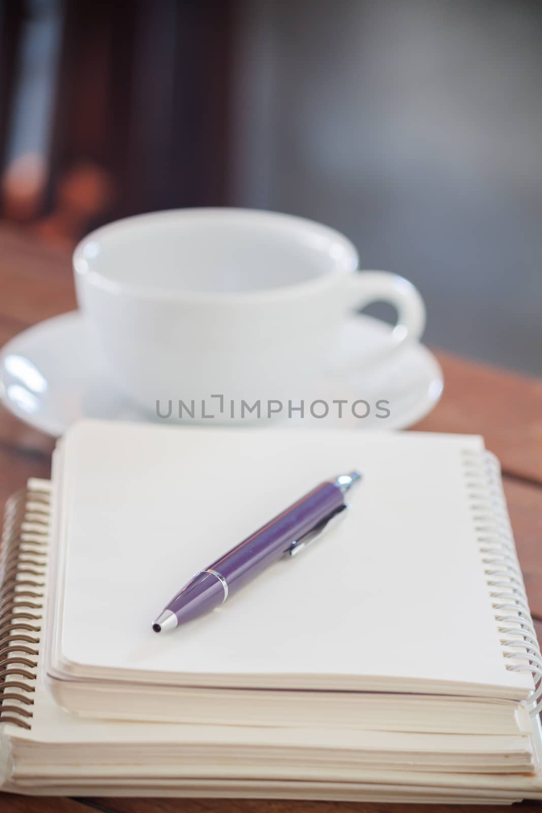 Blank notebook with pen on wooden table, stock photo