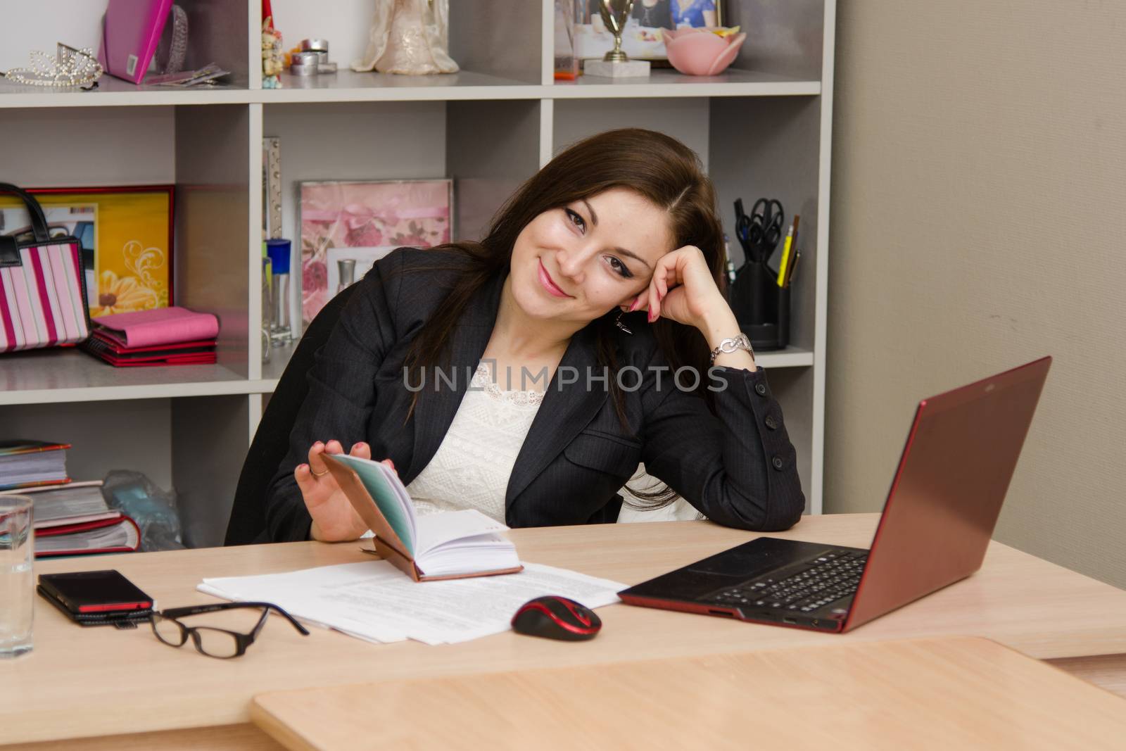 Cute business woman in the office at the computer