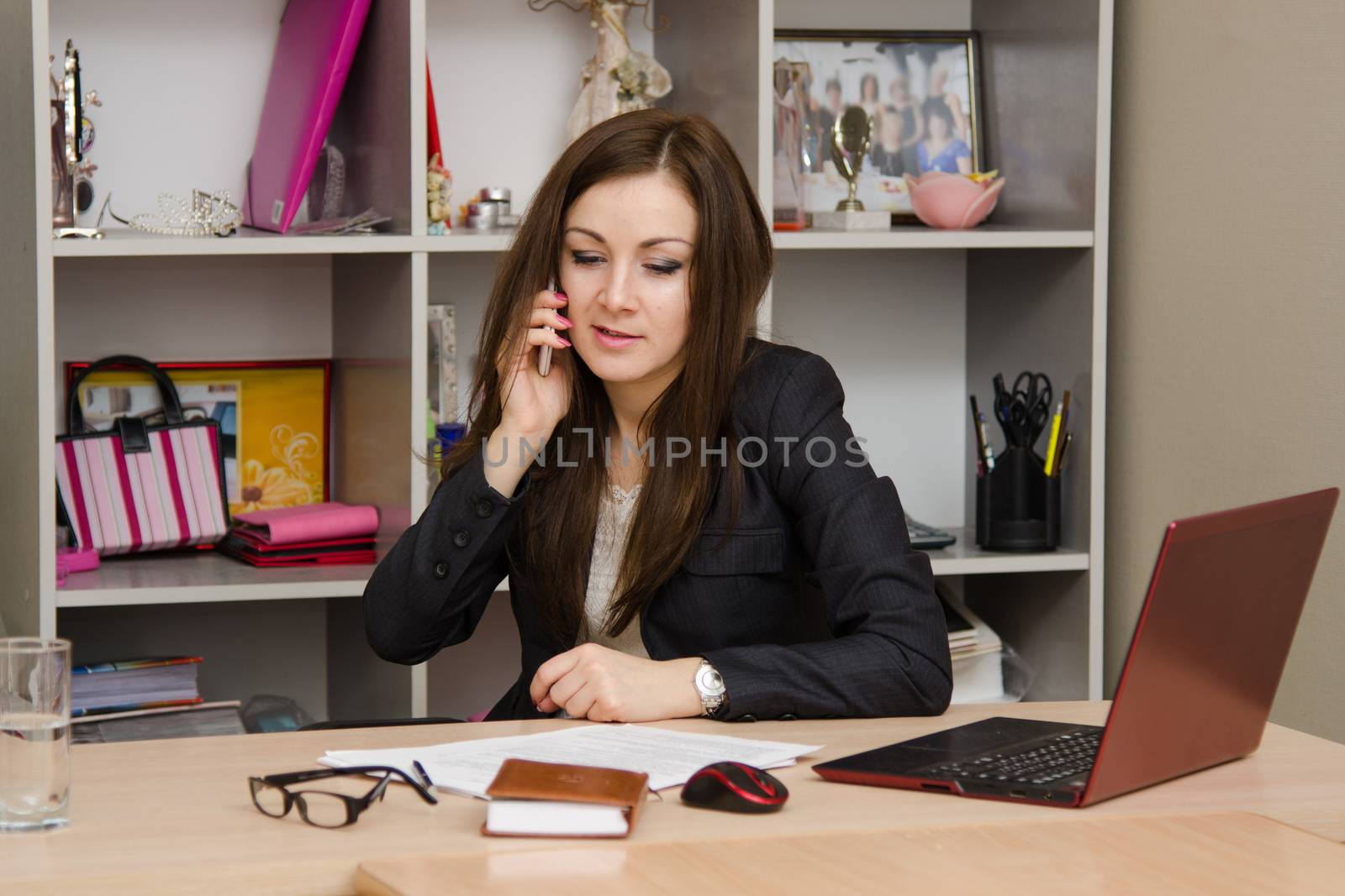 Cute business woman in the office at the computer