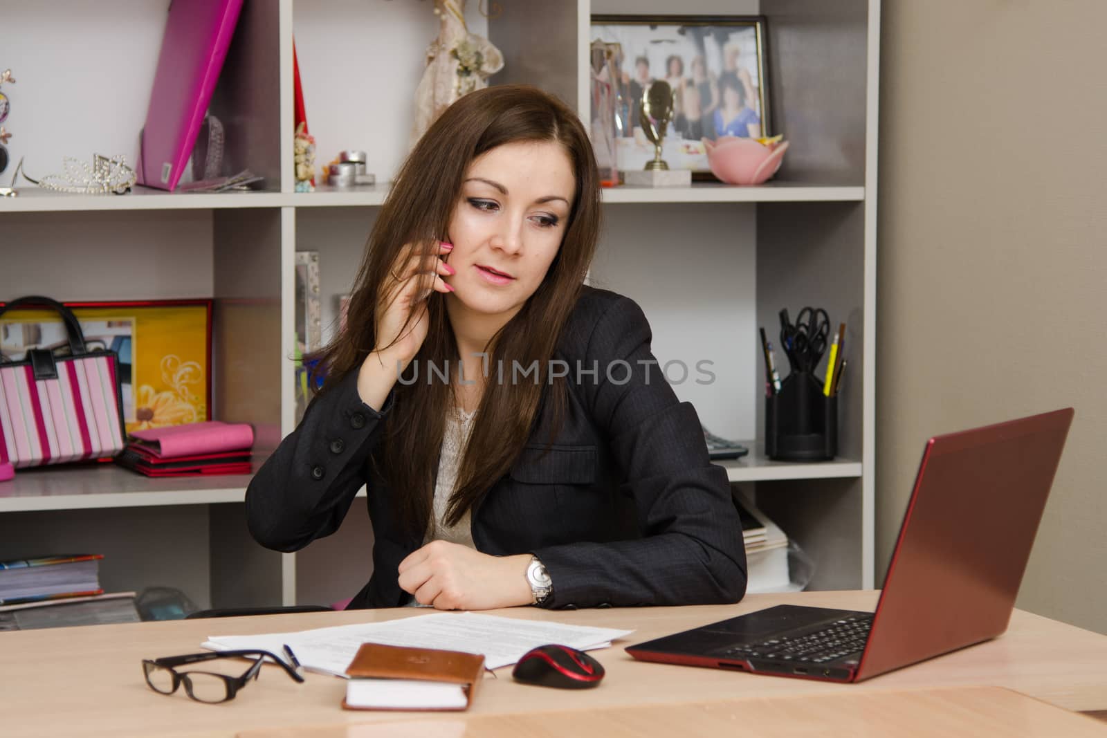 Cute business woman in the office at the computer