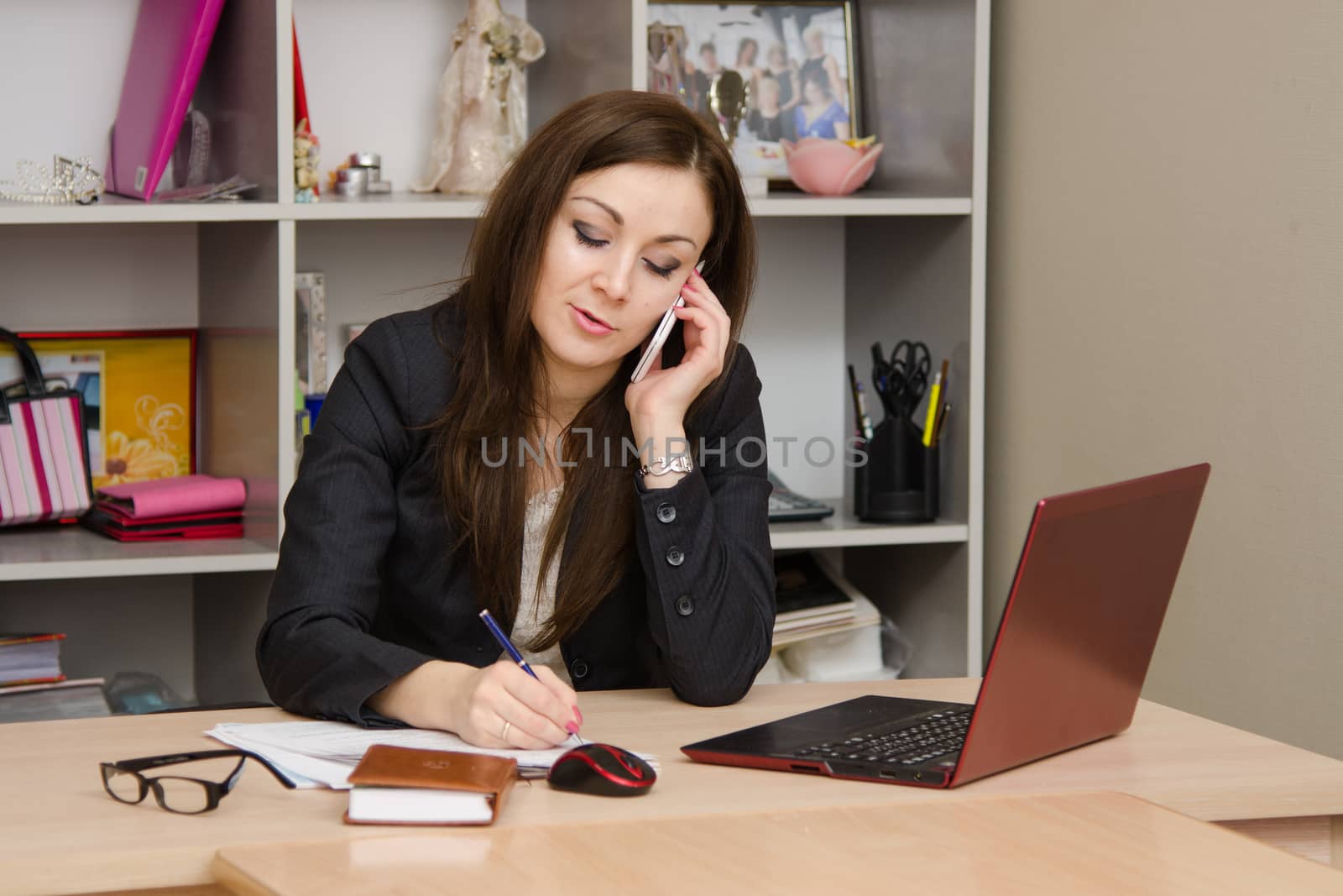 Cute business woman in the office at the computer