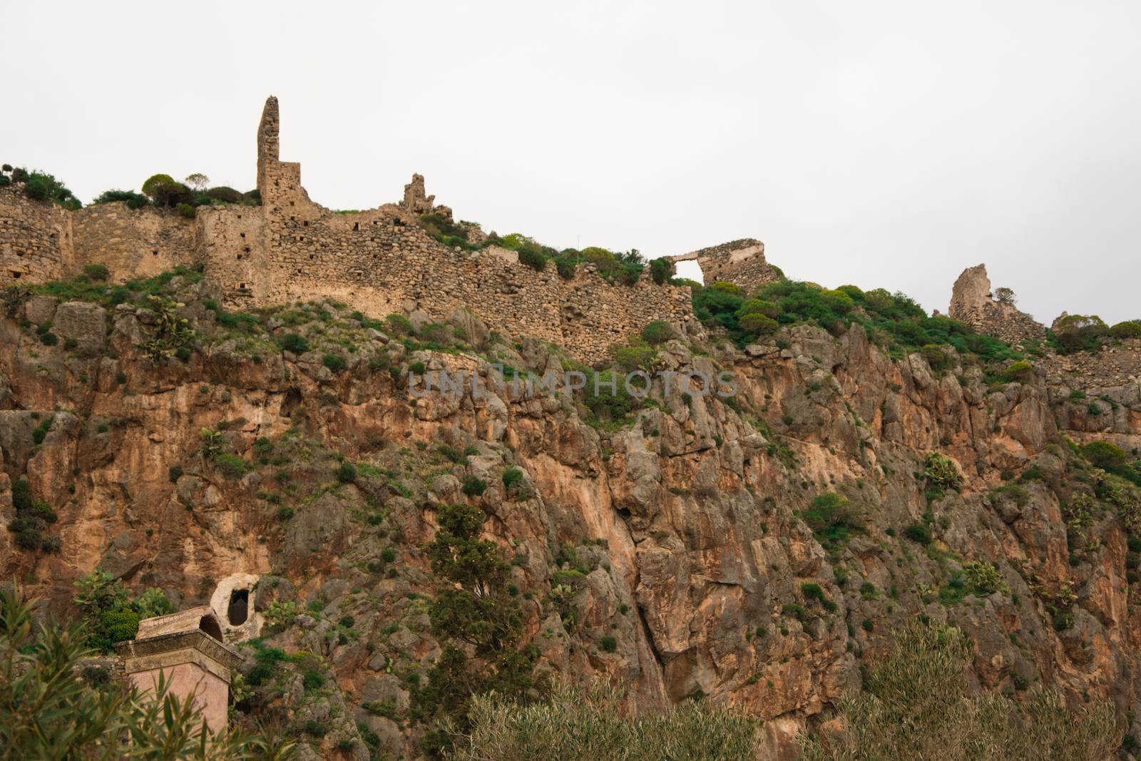 Looking the remnants of the Monemvasia castle in Peloponnese, Greece.