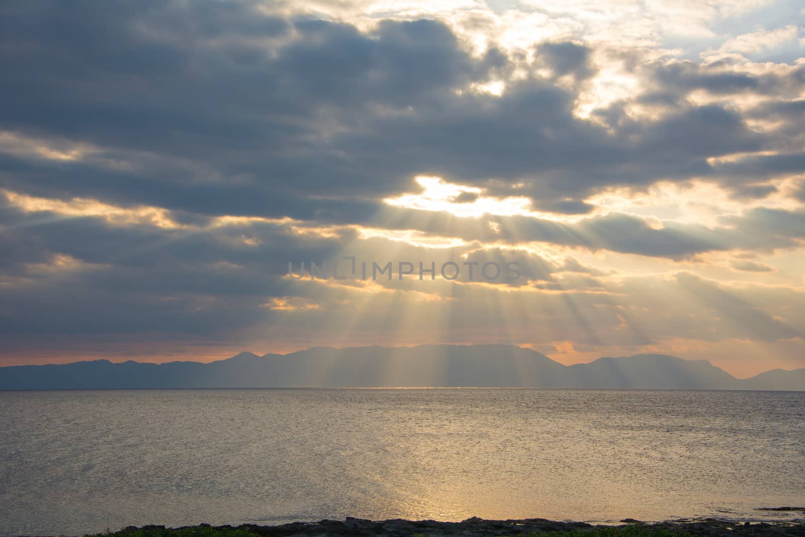 One wonderful sunset at a rocky Greek beach in Peloponnese, Greece.