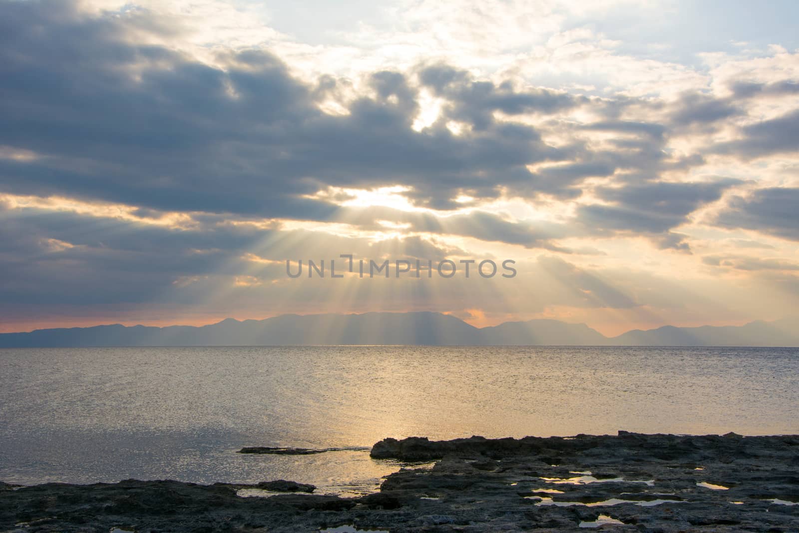 One wonderful sunset at a rocky Greek beach in Peloponnese, Greece.