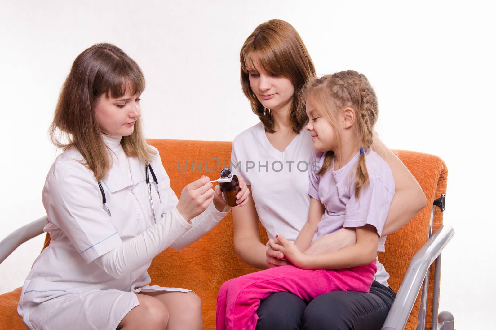 Doctor pediatrician examines a sick child at home in the presence of my mother