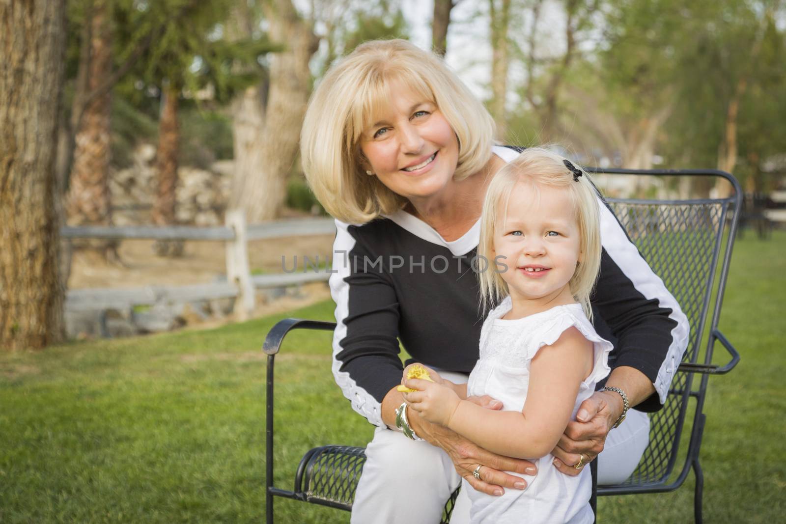 Affectionate Grandmother and Granddaughter Playing Outside At The Park.