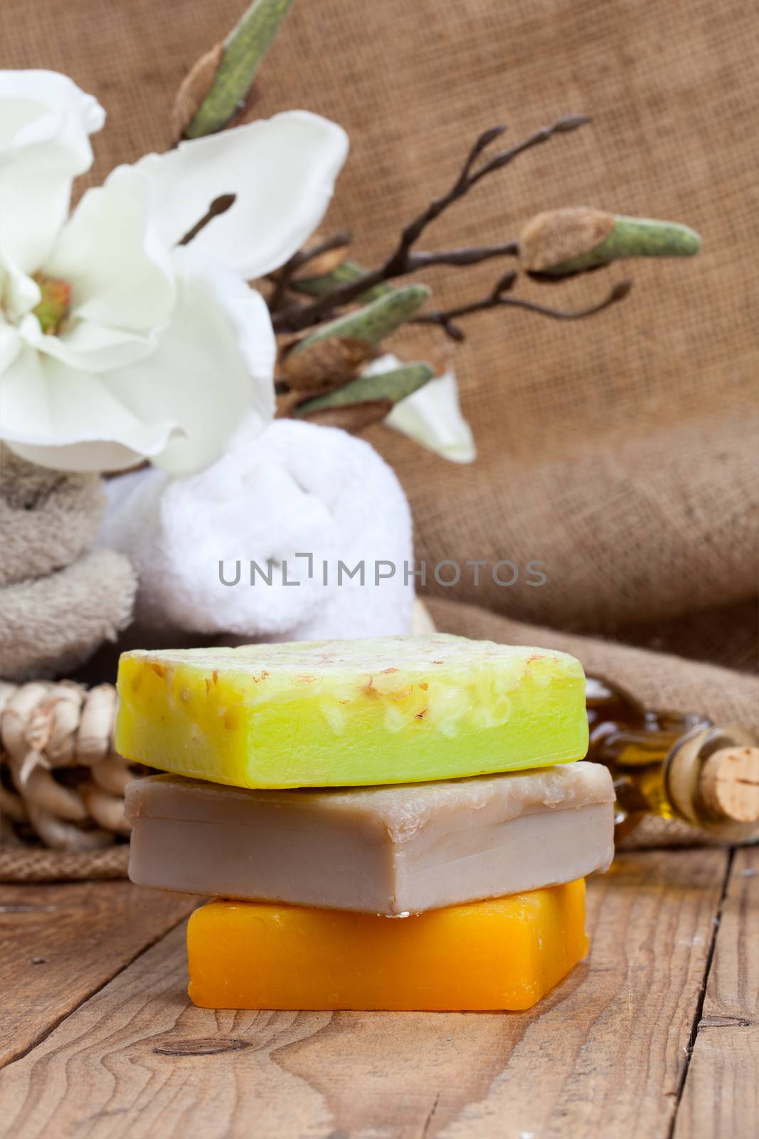 colorful handmade soap bars, on wooden background by motorolka