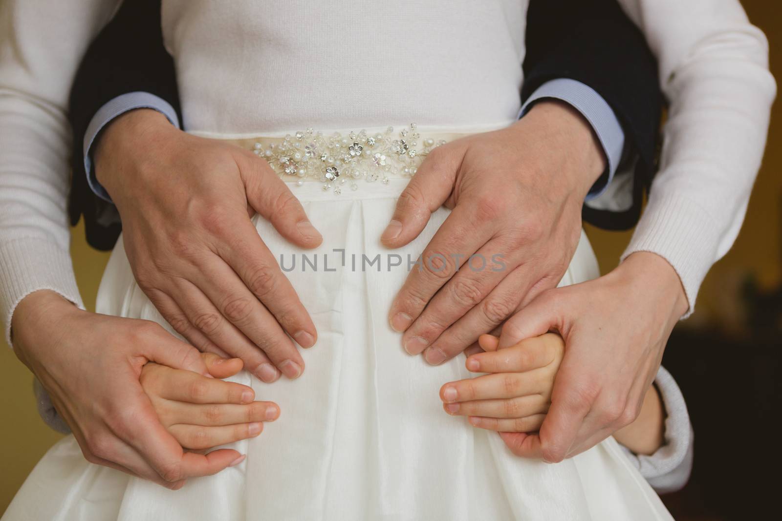 Family holding hands together closeup by sarymsakov