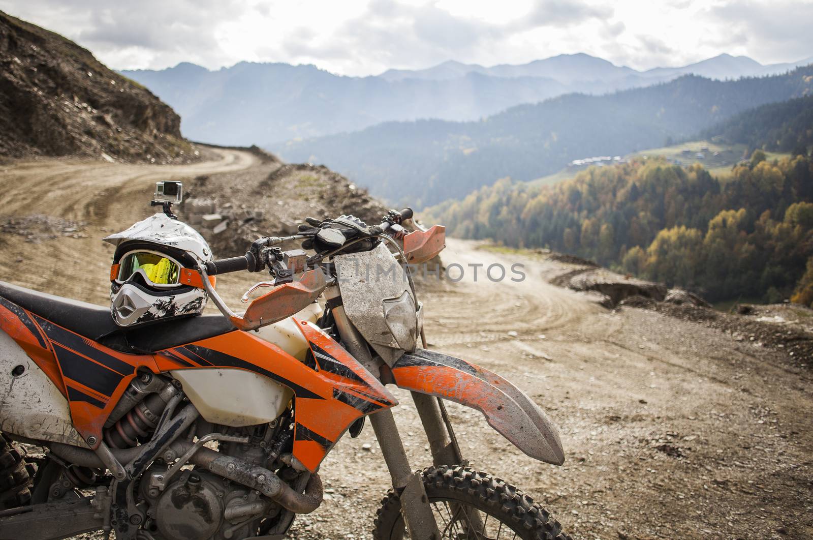 Dirty enduro motorcycle motocross helmet on road by Kor