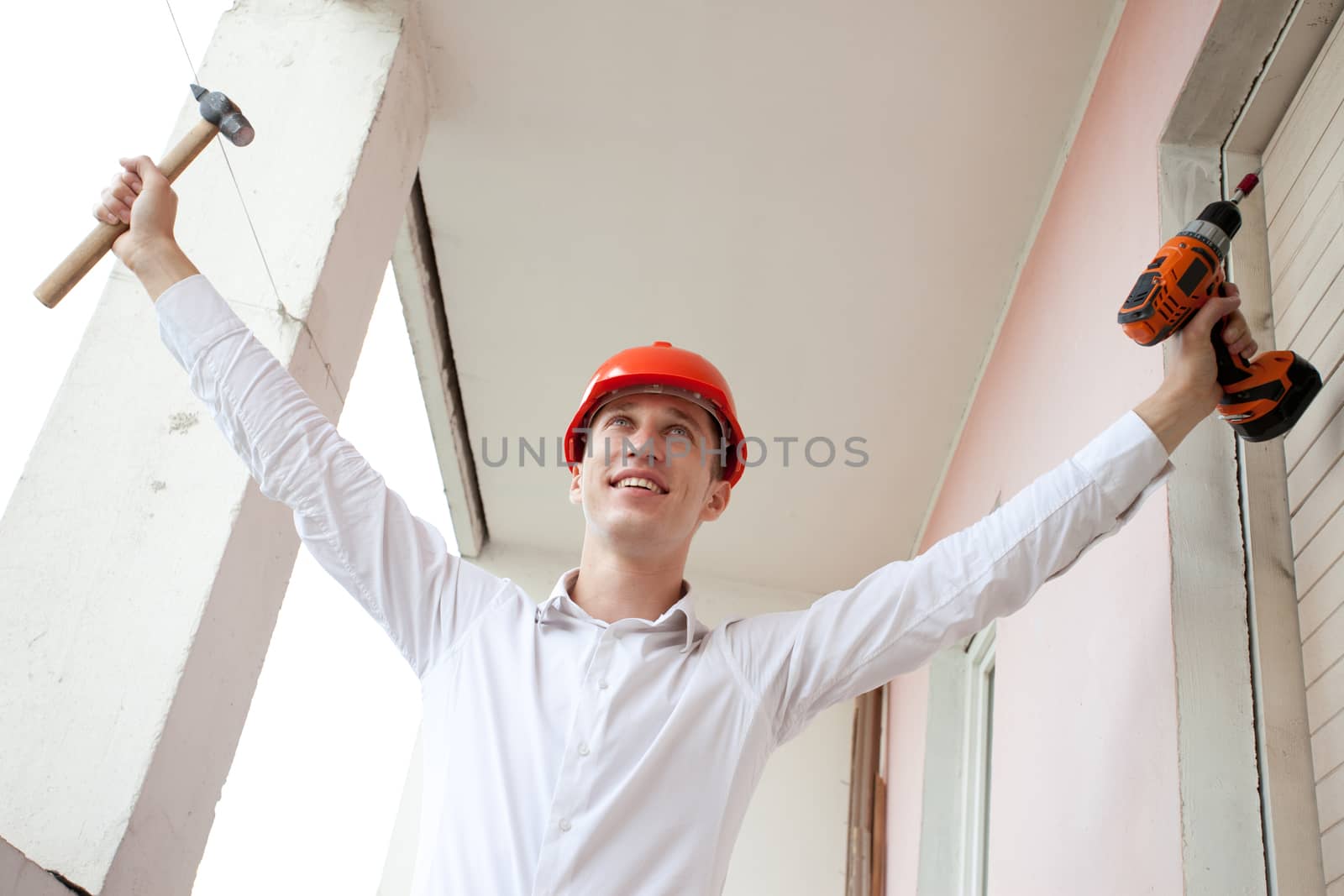 engineer with a tools in raised hands by Astroid
