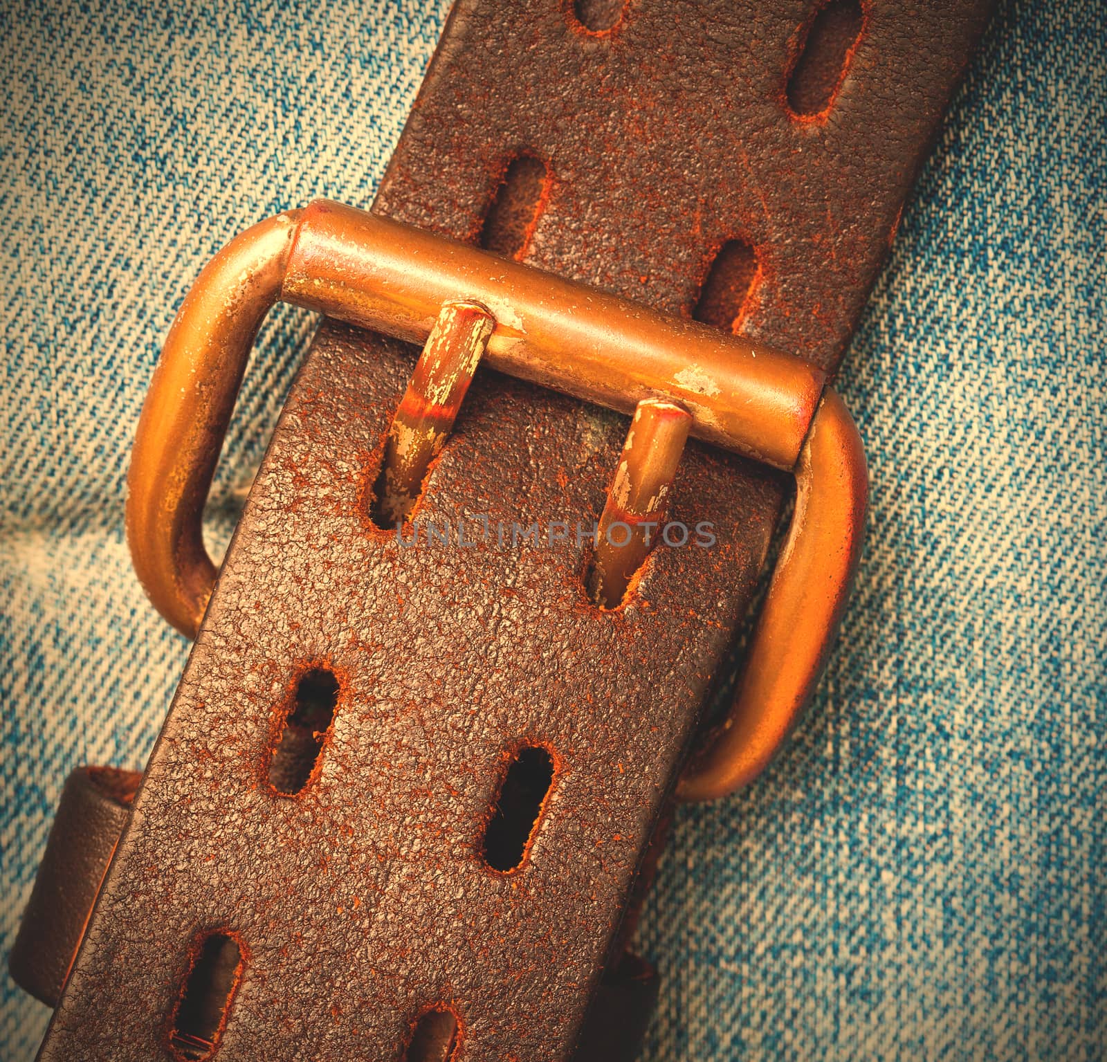 vintage leather belt with buckle on the jeans background. instagram image style