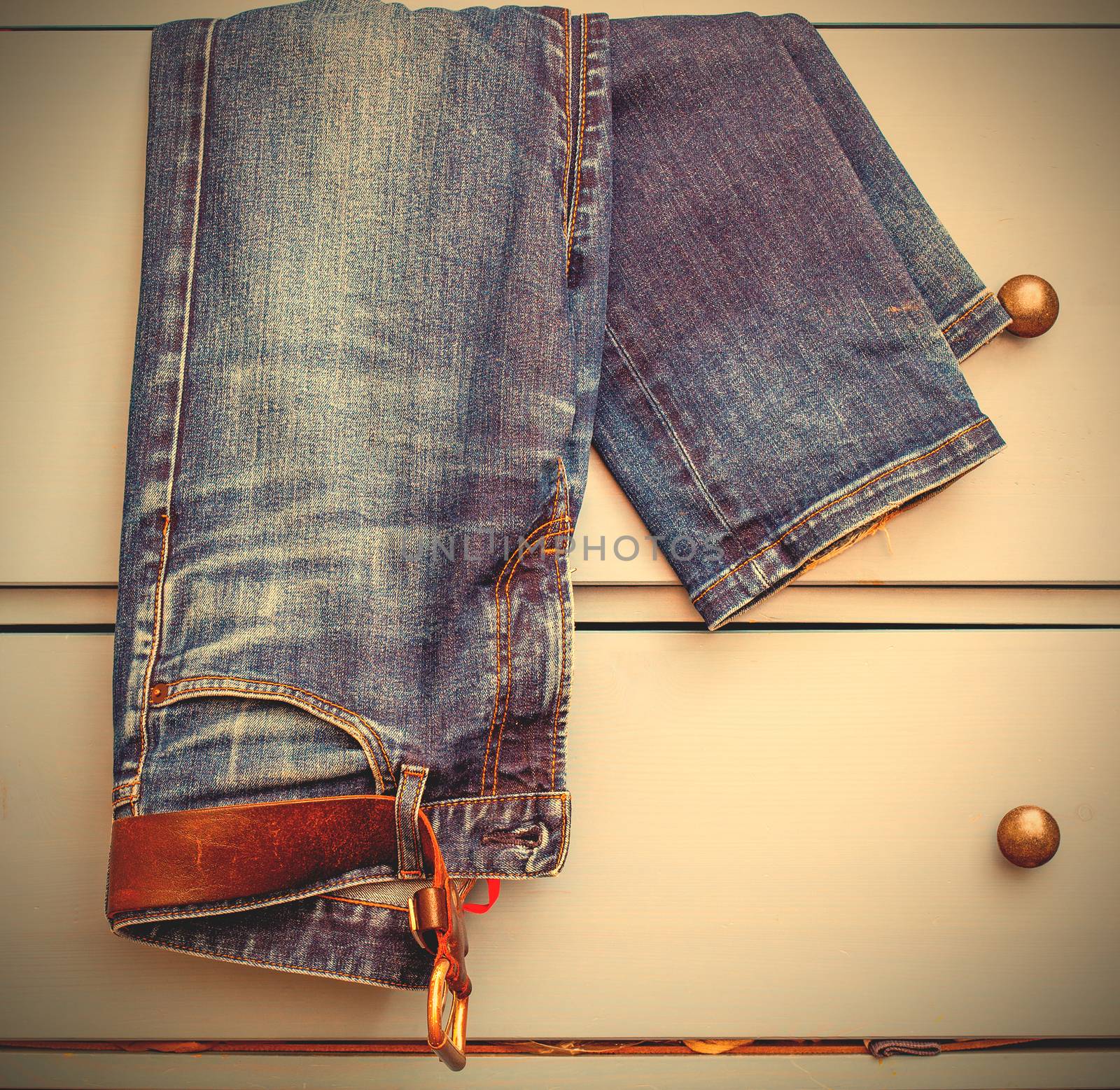 old Jeans protrudes from the drawer by Astroid