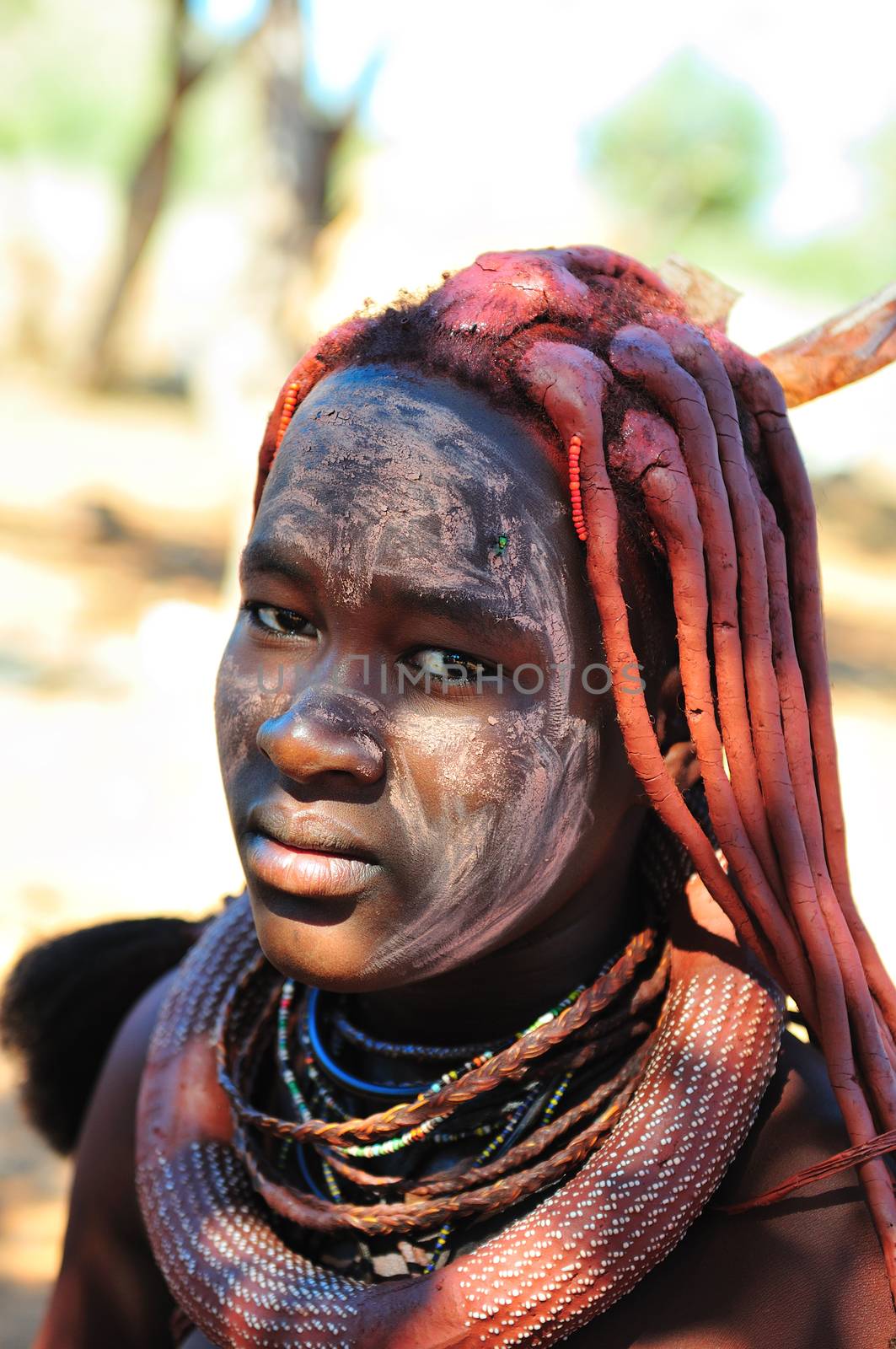 EPUPA, NAMIBIA - MAY 2011: An unidentified Himba woman poses for photographers at a Himba village on May 27th, 2011. Entrance fee to the village is a specified food parcel