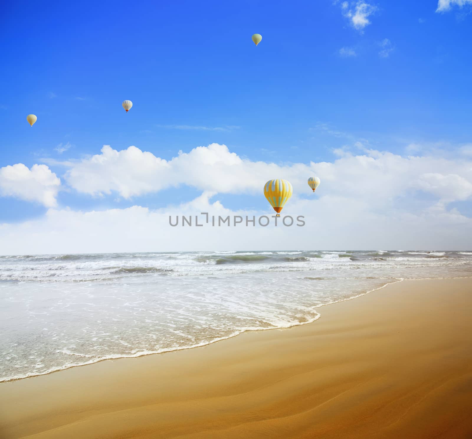 Air balloons flying over the tropical summer beach