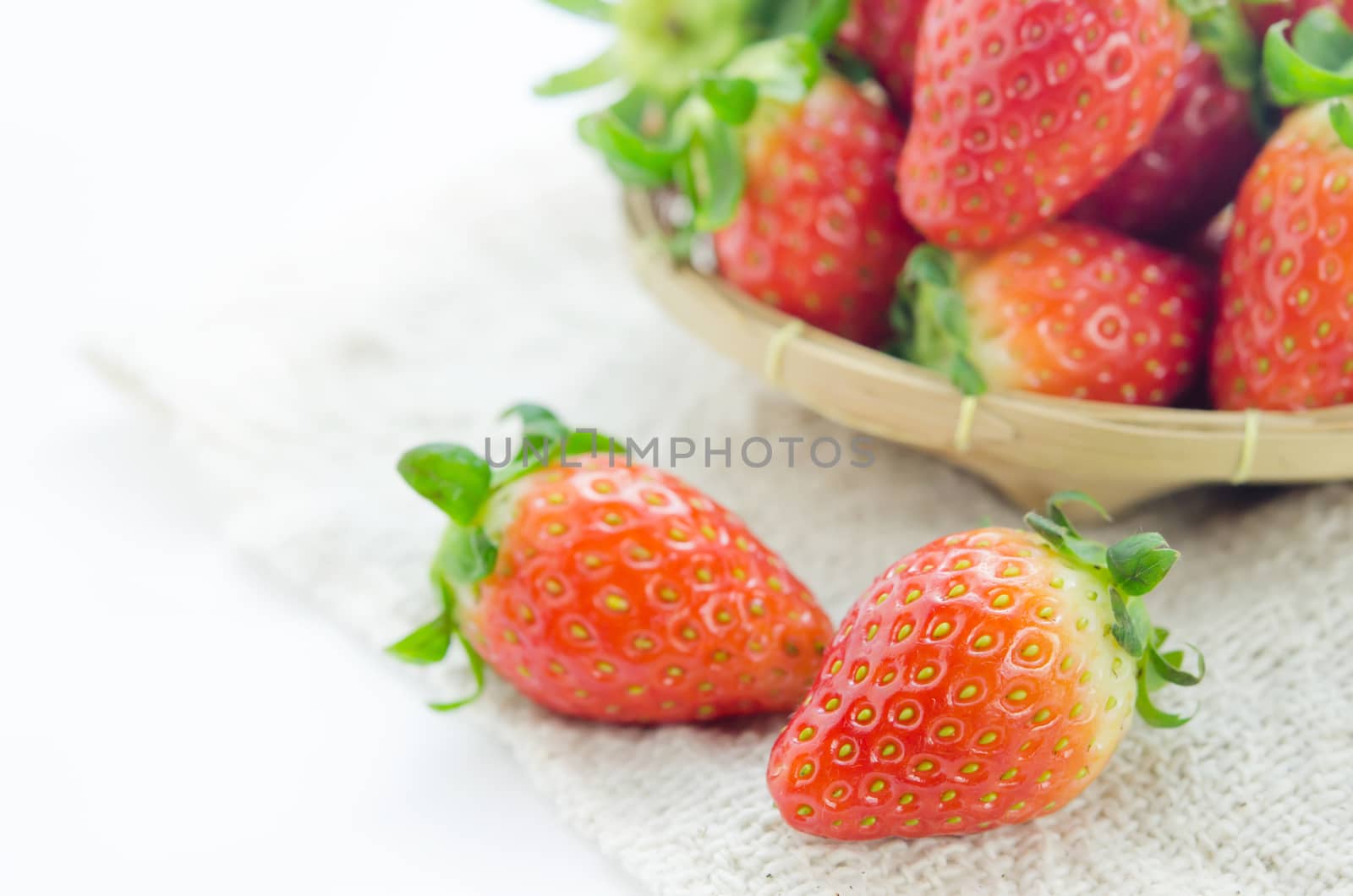 close up fresh red strawberries over sackcloth , ripe fruit