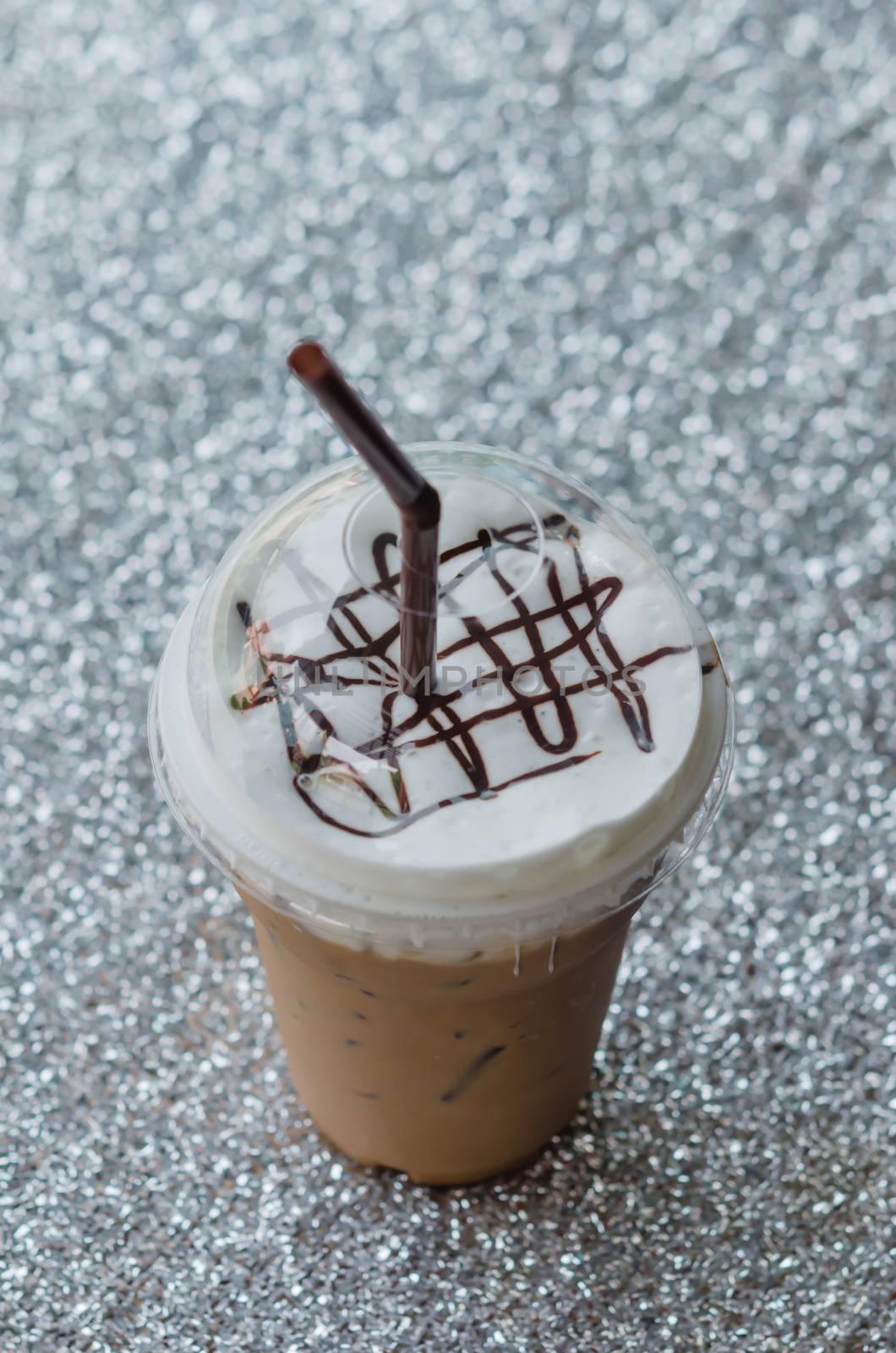 Iced coffee with straw in plastic cup for take aways