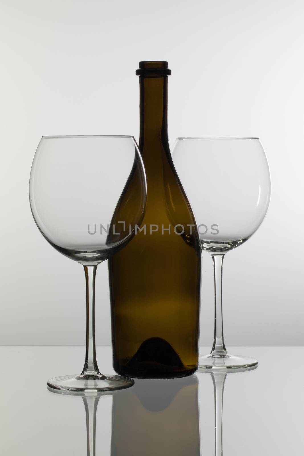 Empty wine glasses on the glass table by CaptureLight