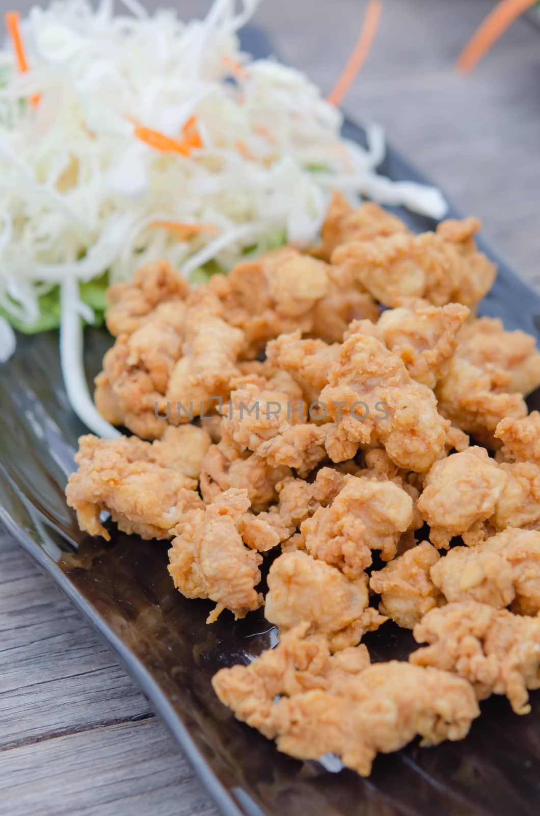 deep fried chicken tendons with fresh vegetable and chili sauce, asian style cuisine