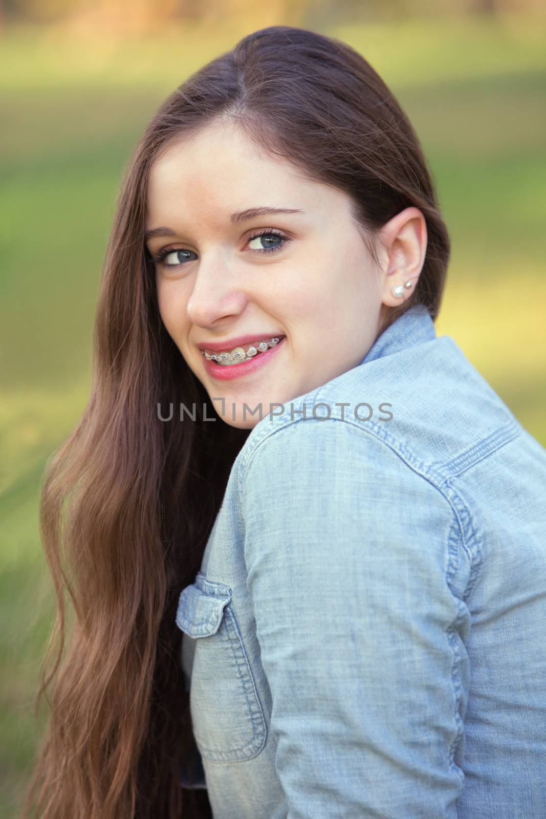 Pretty teenage girl smiling and looking over her shoulder