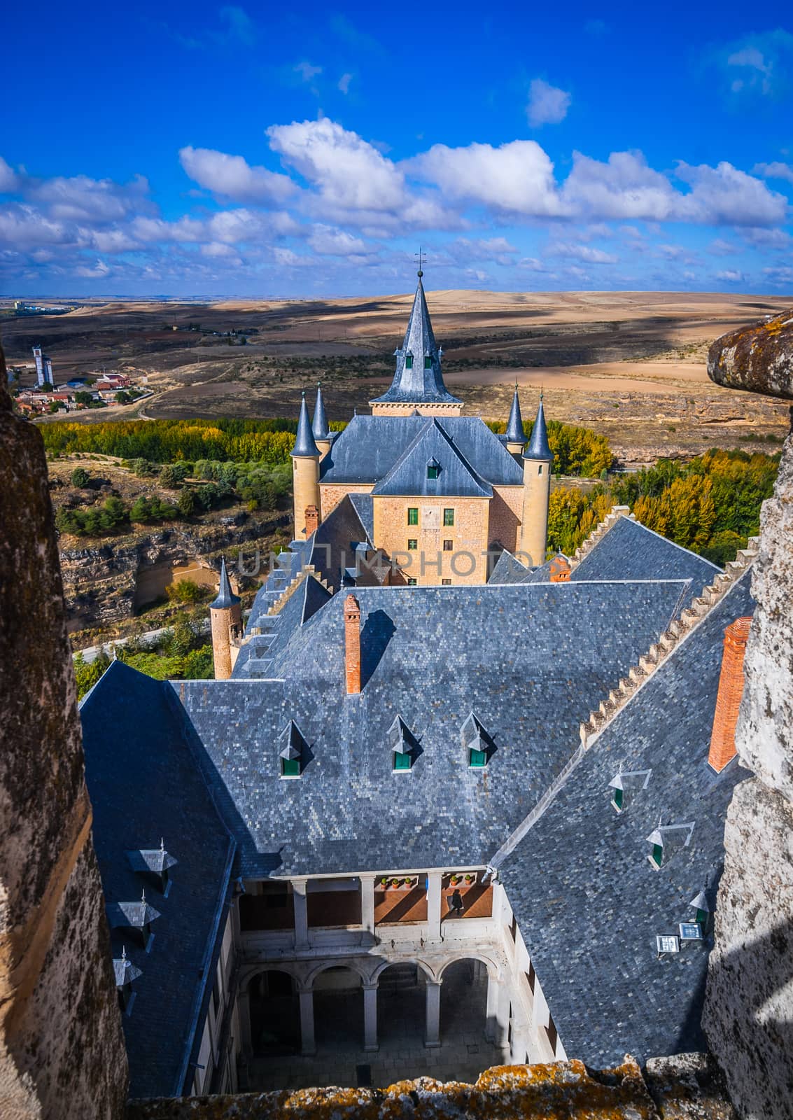 A high up view of the Spanish rural countryside and the castle, from the castle Alcazar.