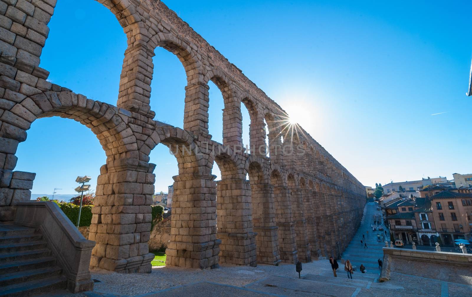 Sun rises on the Segovia Market Square and famous Aqueduct.