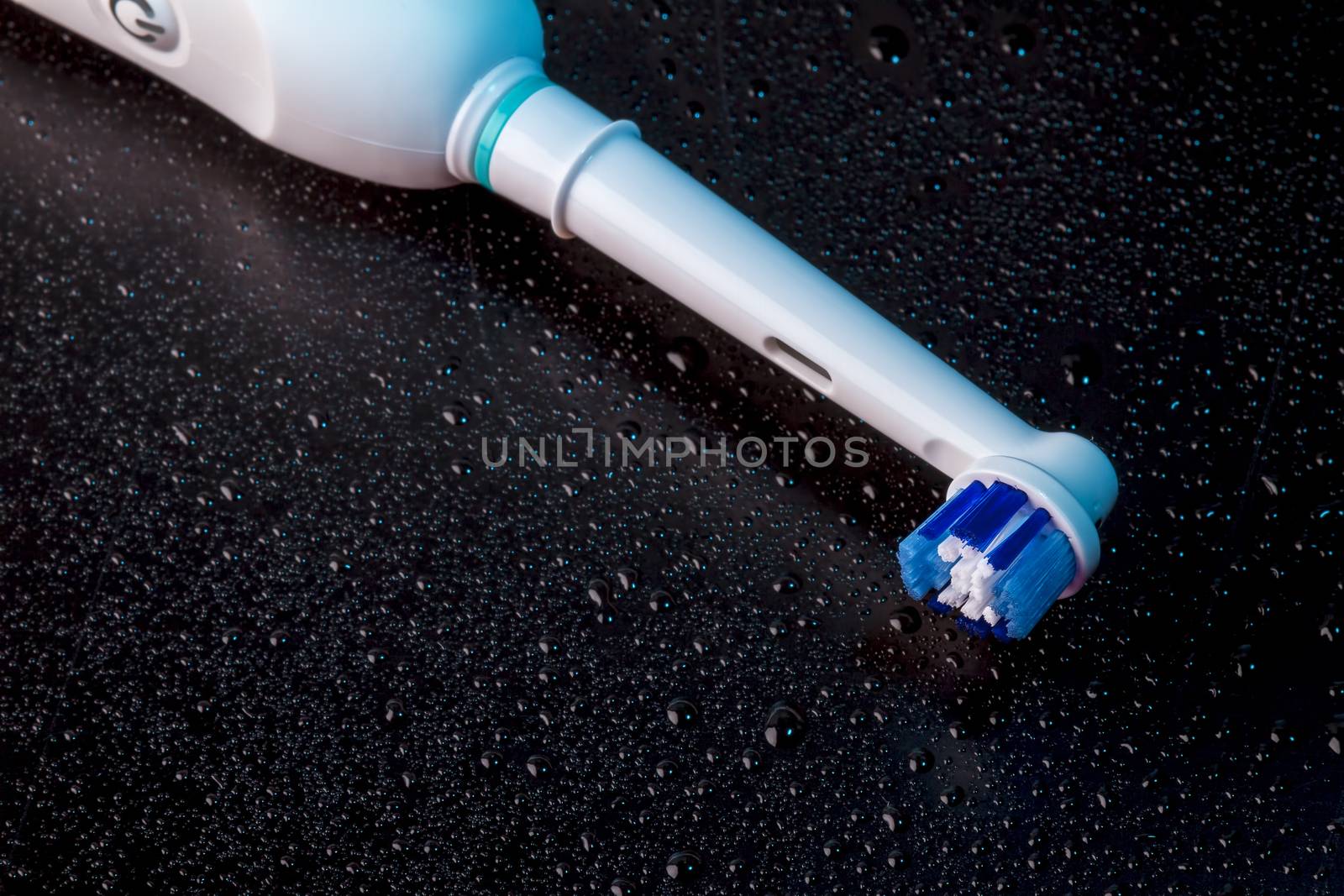 White Electric Toothbrush on Black  by manaemedia