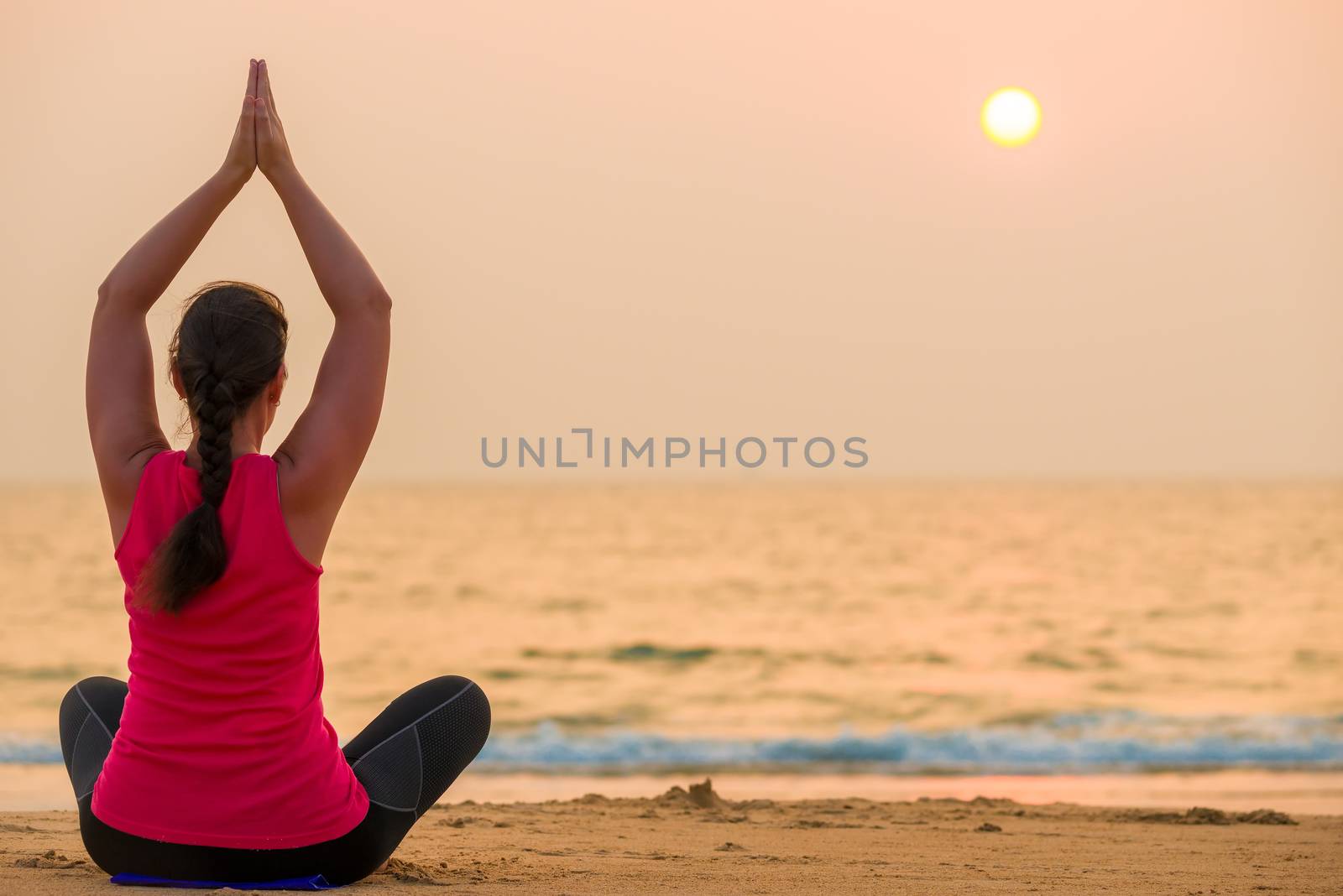 beautiful sunset over the sea and athletic girl