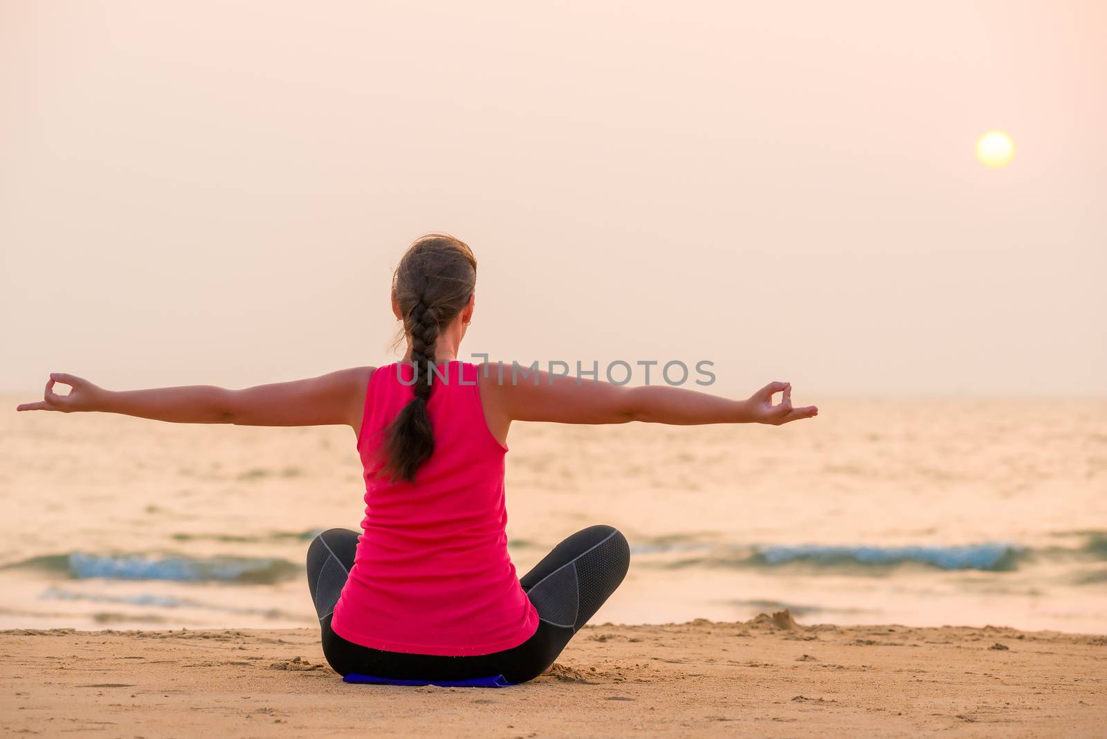Woman in lotus position with arms outstretched to the sides by kosmsos111