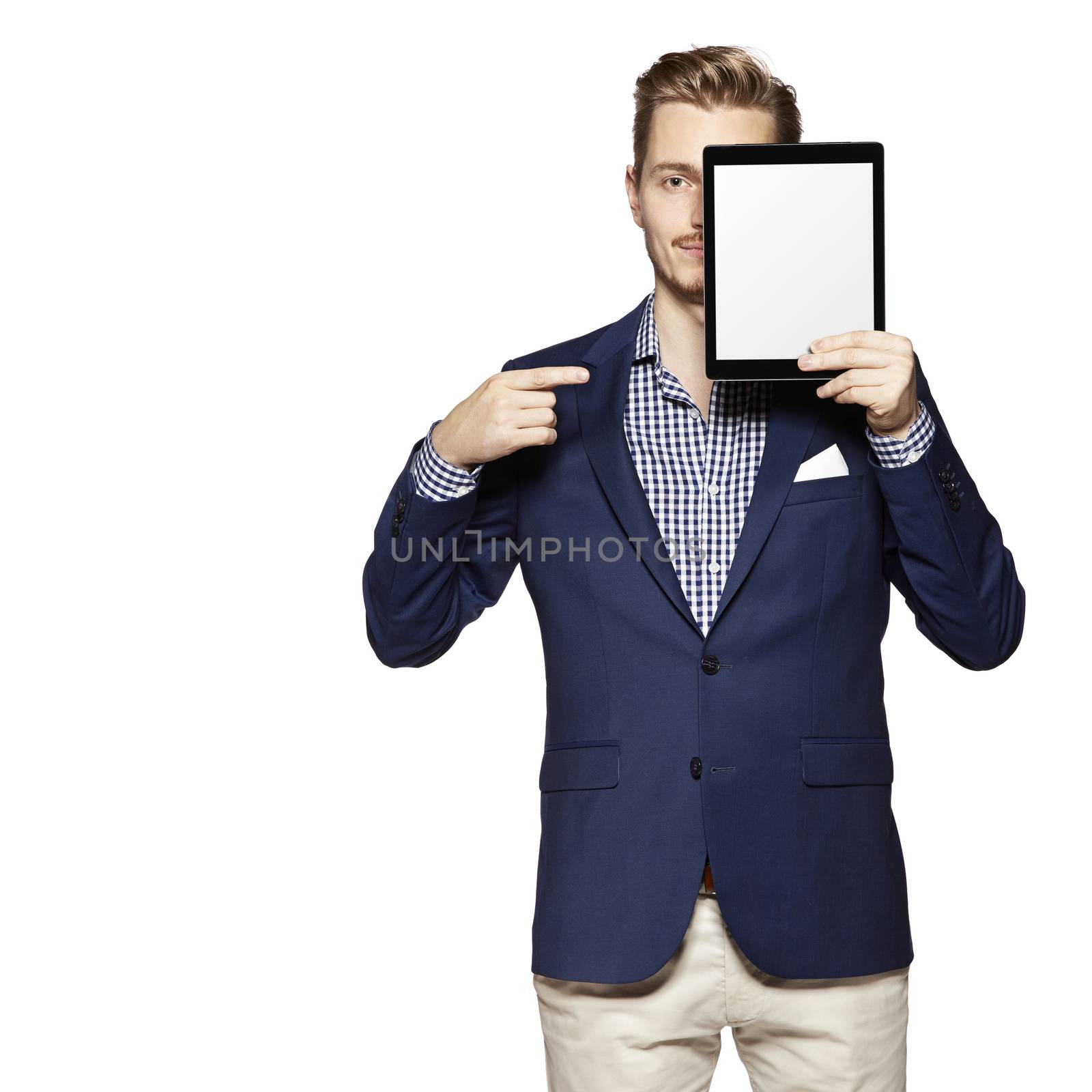 Portrait of a cheerful young man is showing something on digital tablet.