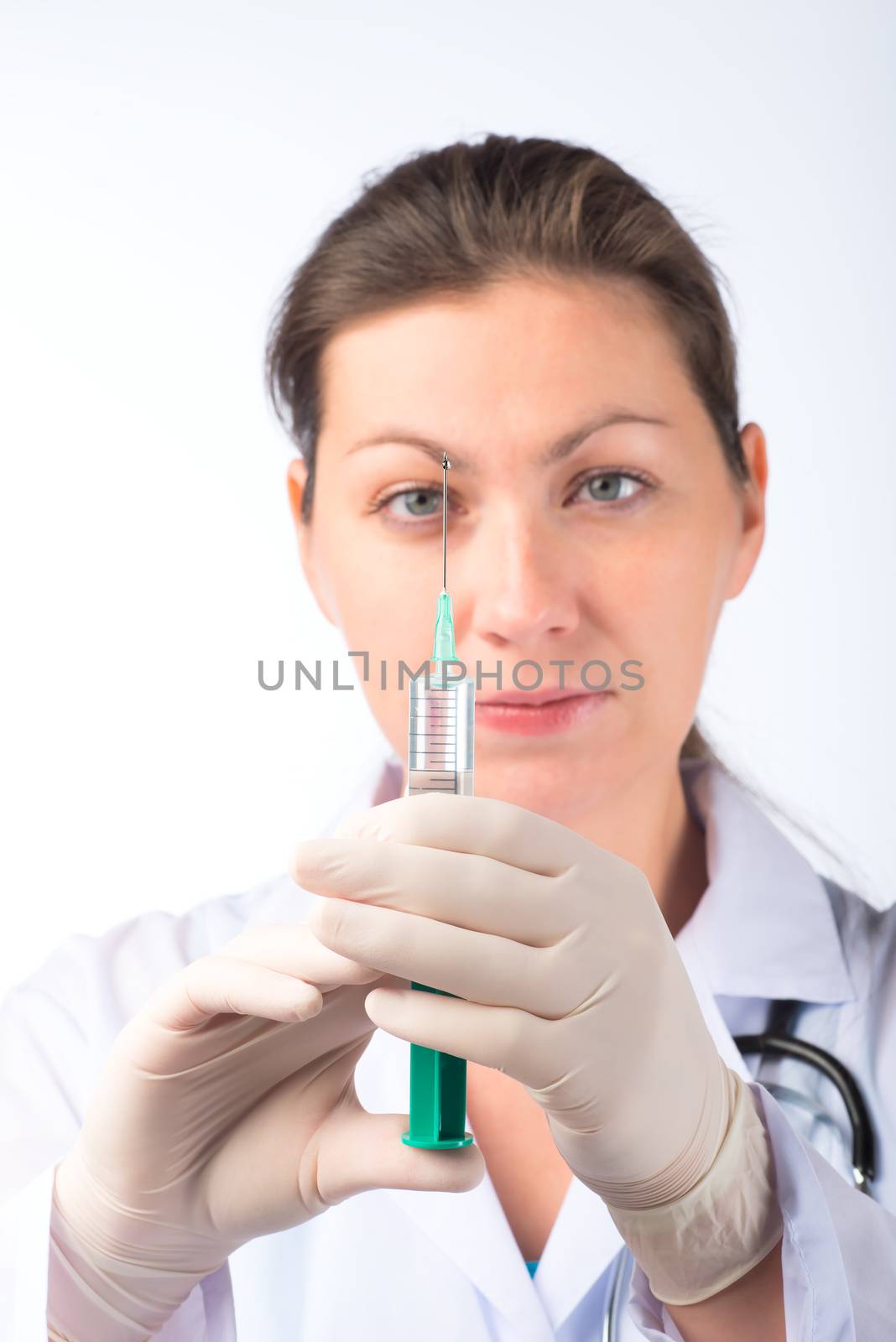 portrait of a nurse with a syringe in gloves