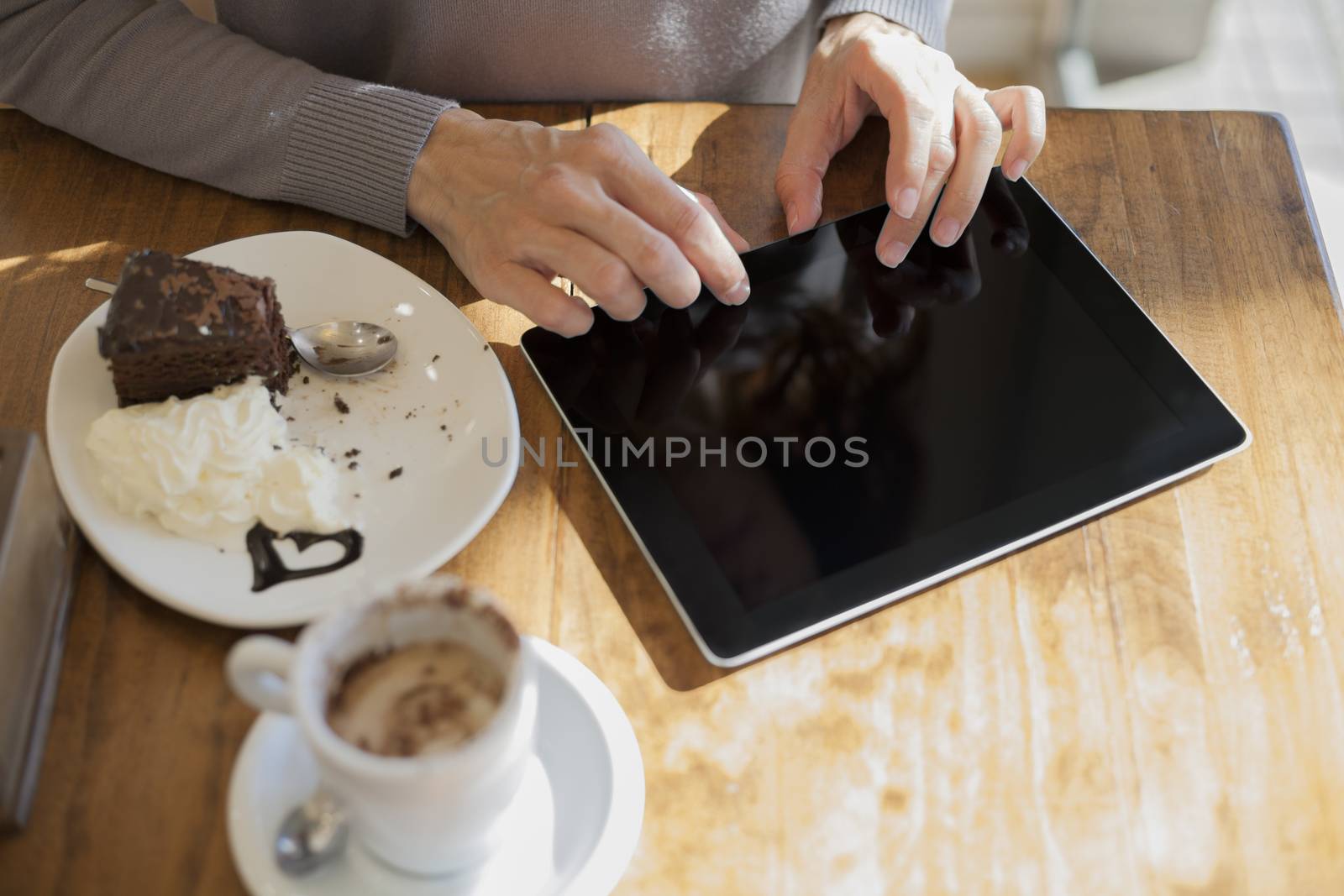 typing on blank screen tablet breakfast by quintanilla