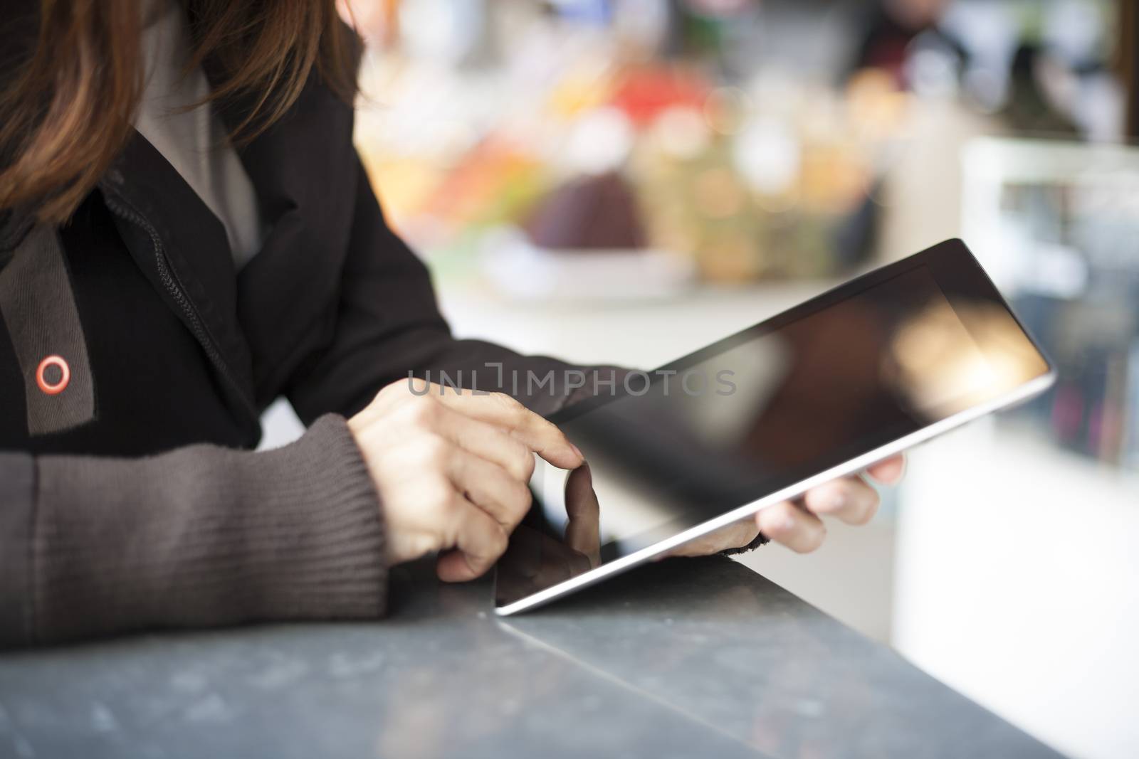 woman hands with digital tablet blank screen in a public market