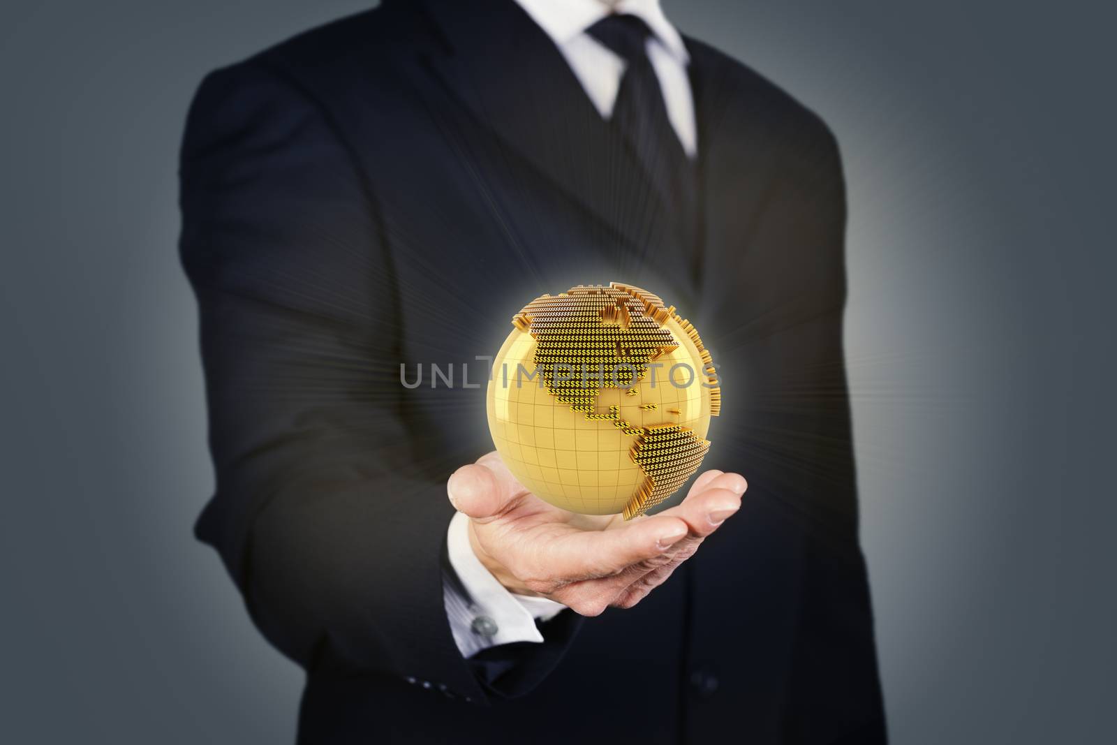 Businessman holding a golden globe by ymgerman