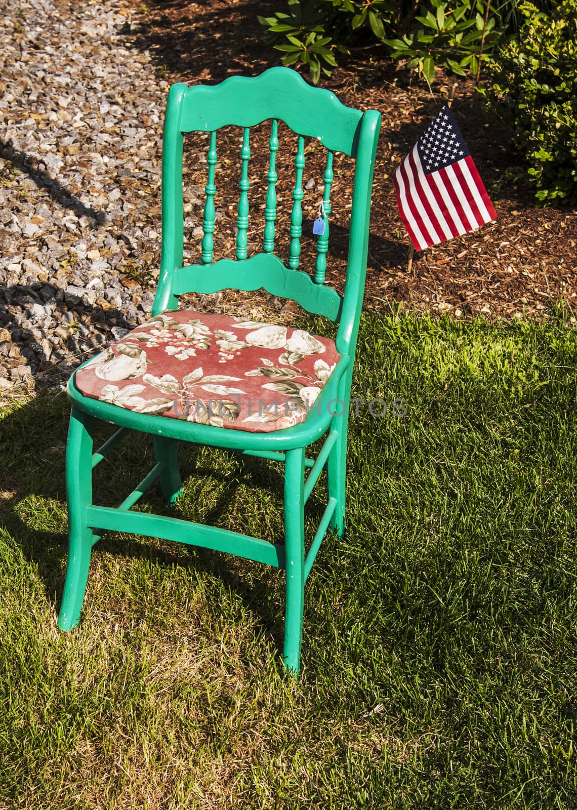 old fashioned green chair in an american garden