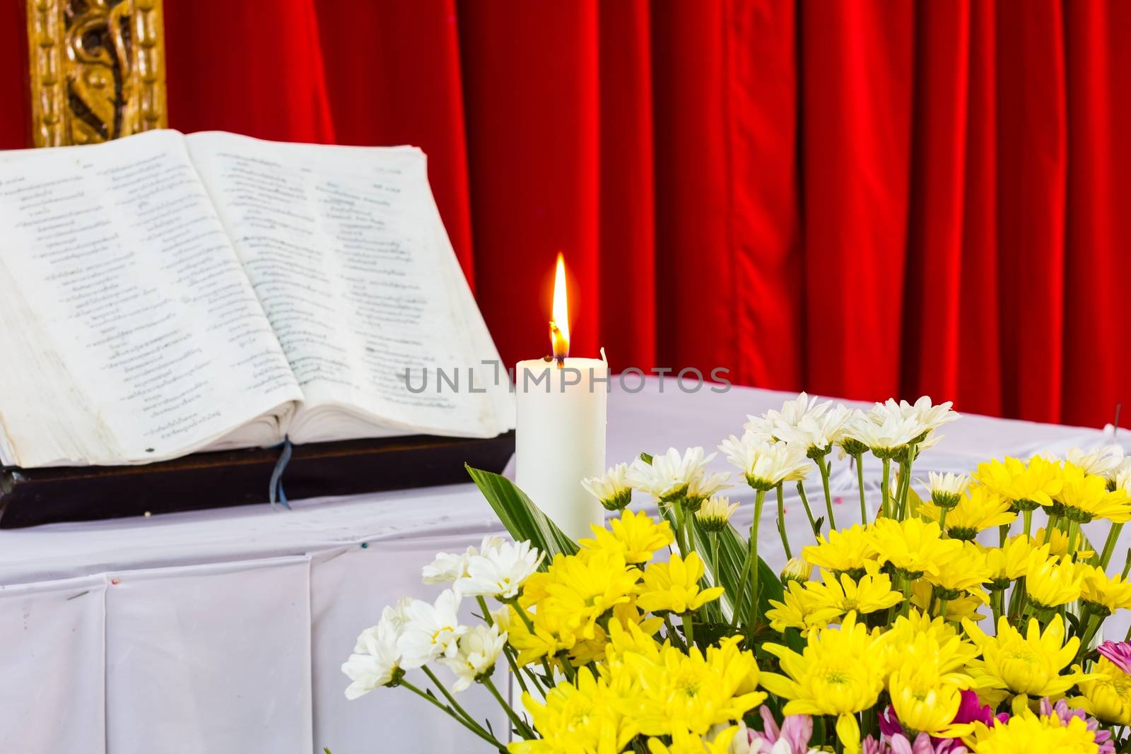 bible open on a table with candle by a3701027
