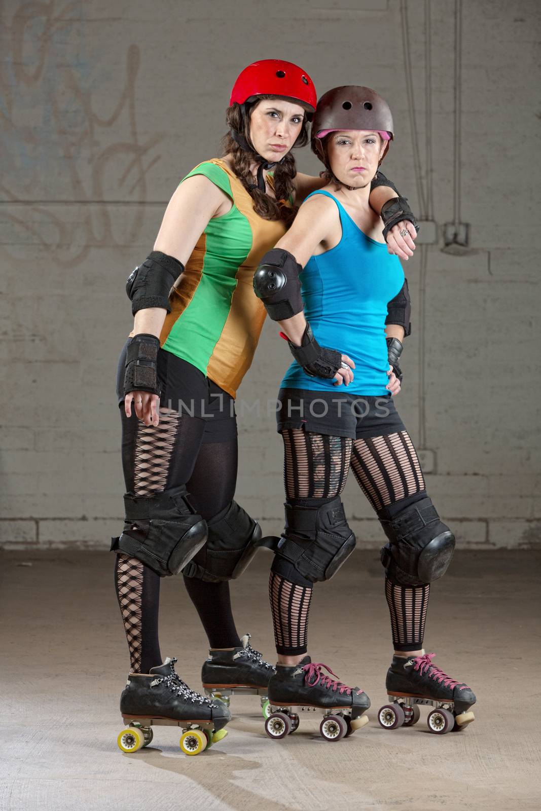 Serious adult female roller derby skaters as friends