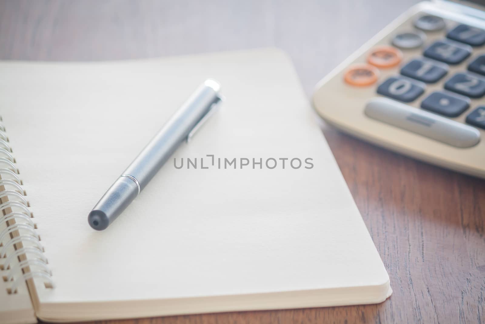Blank notebook with pen on wooden table, stock photo