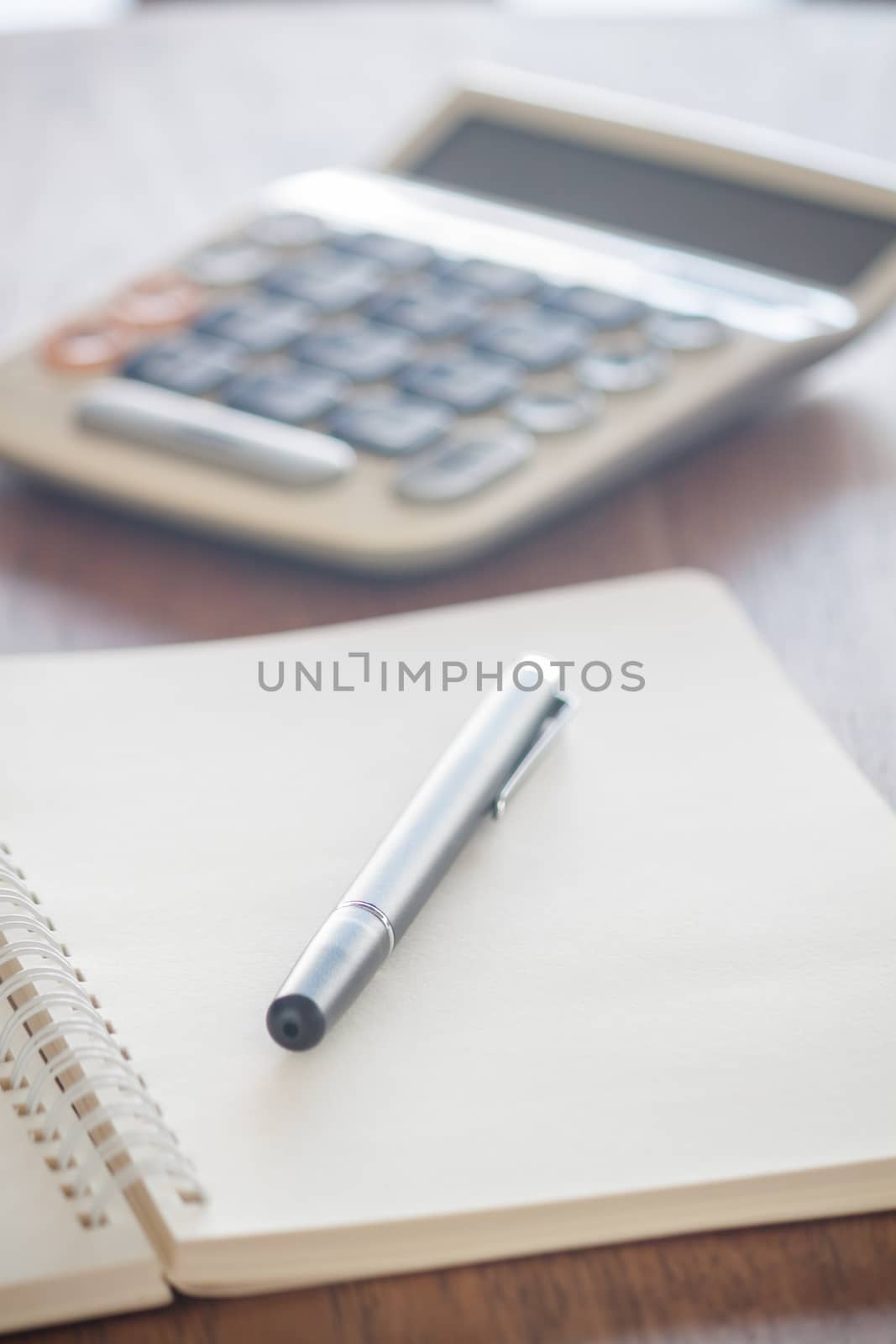 Blank notebook with pen on wooden table, stock photo