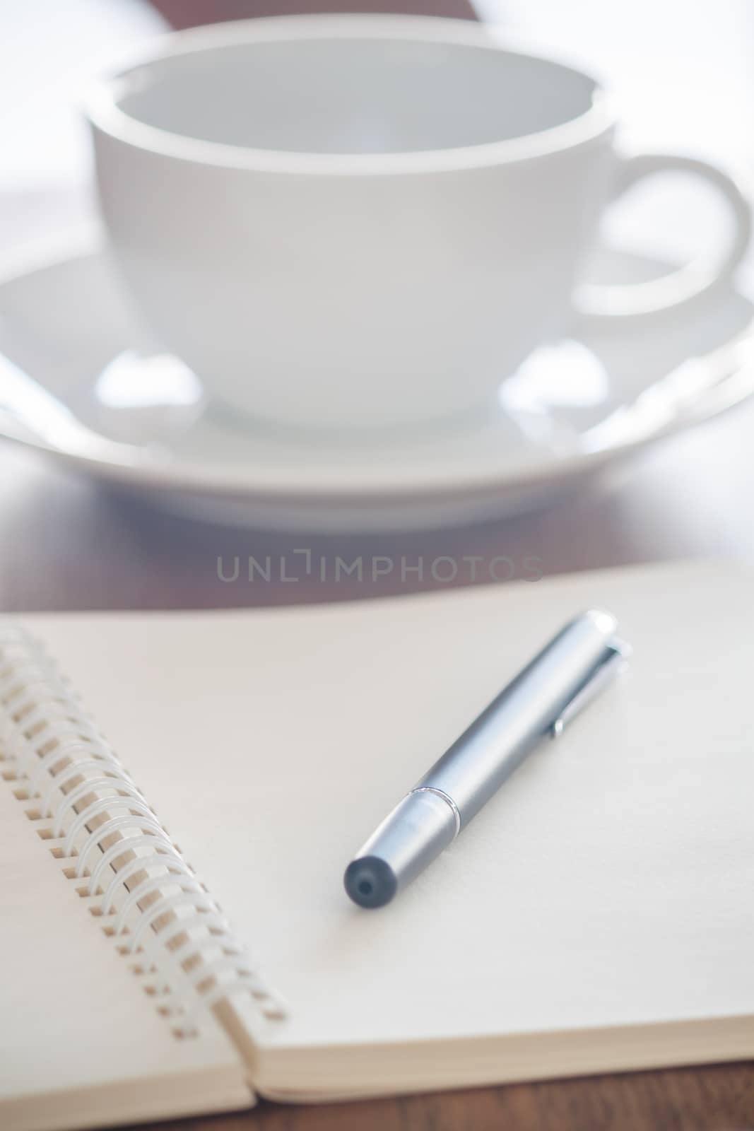 Blank notebook with pen on wooden table, stock photo