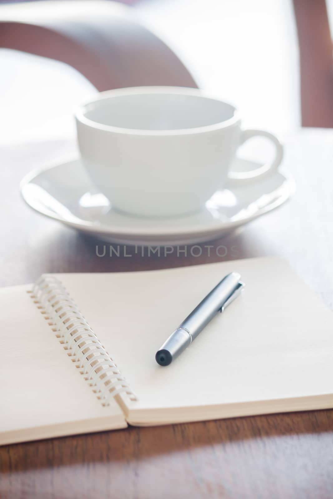 Blank notebook with pen on wooden table, stock photo