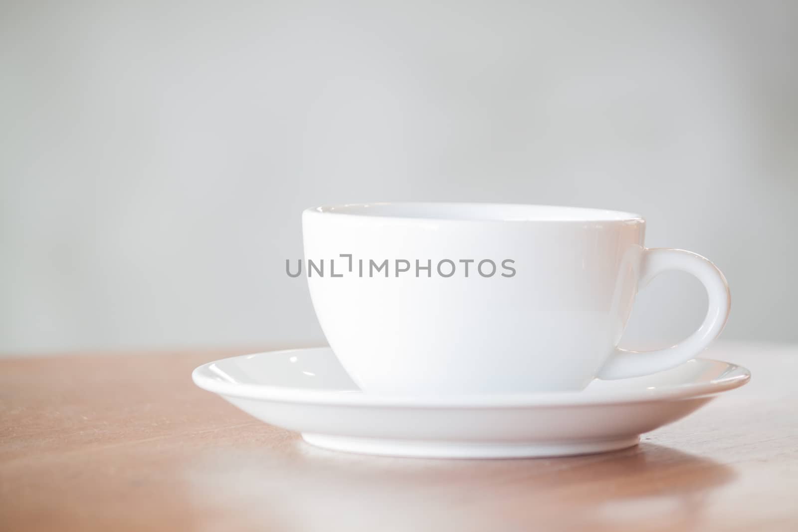 White coffee cup on wooden table, stock photo