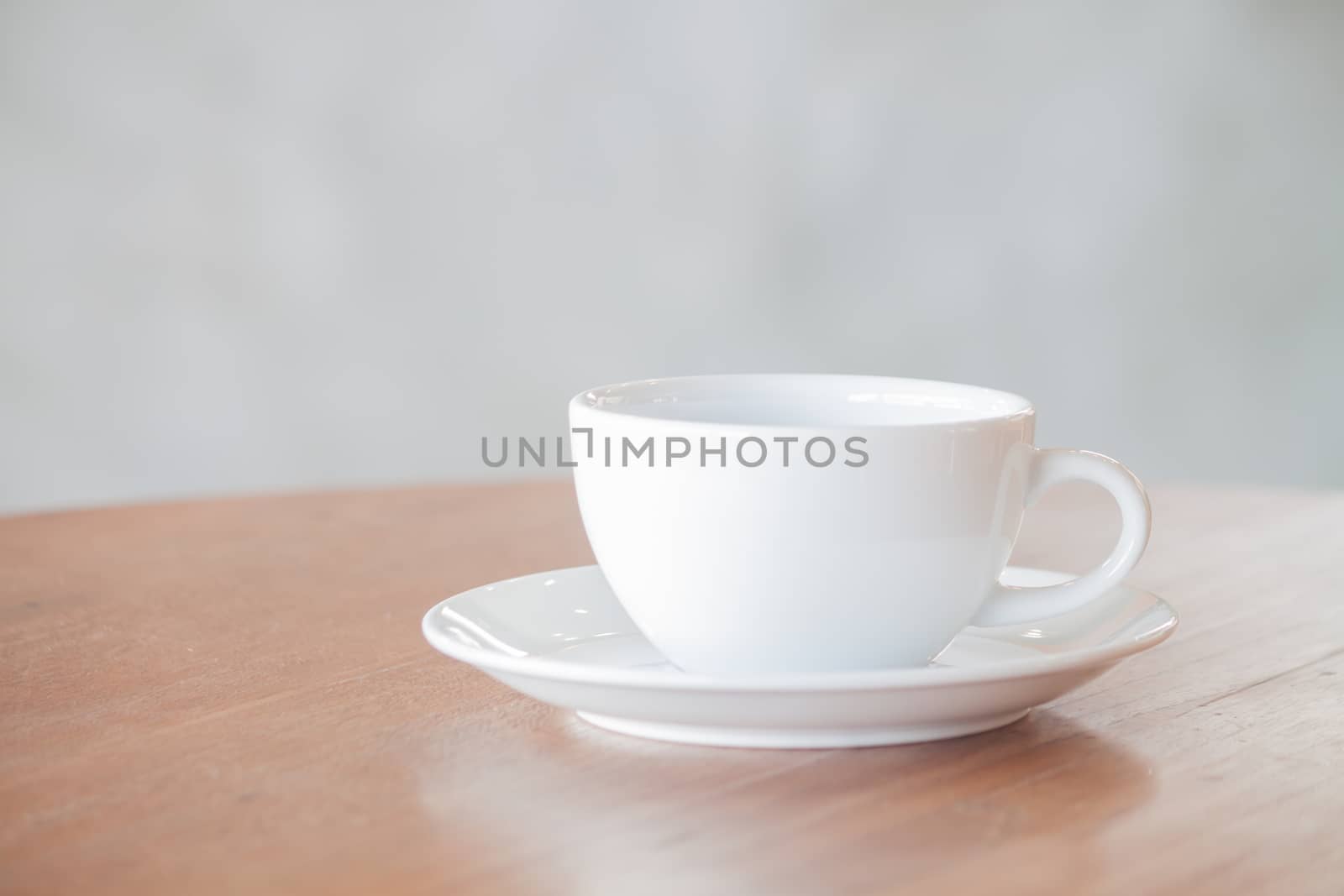 White coffee cup on wooden table, stock photo